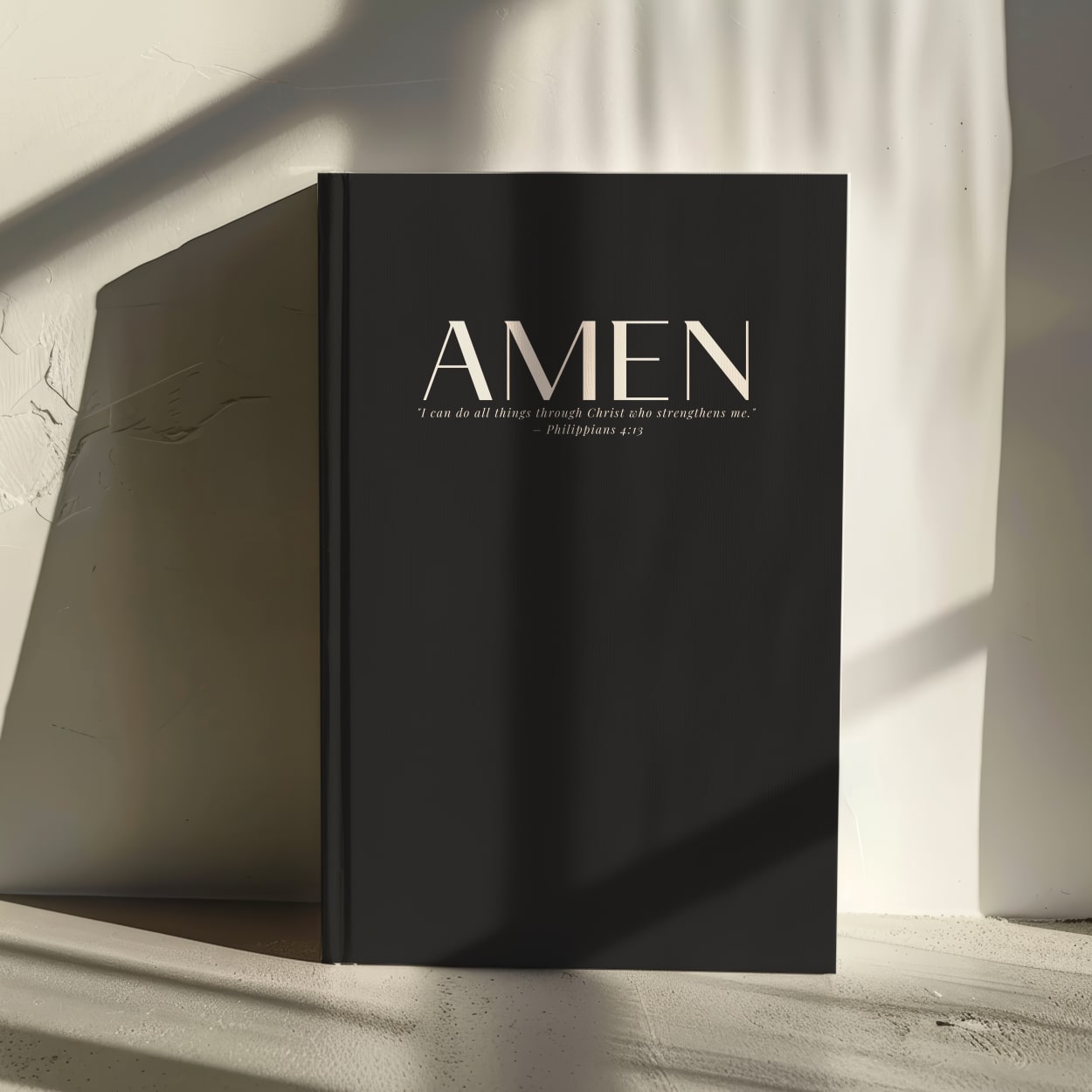 Black luxury hardcover journal with 'Amen' and Philippians 4:13 on the cover, in an elegant minimalist font.