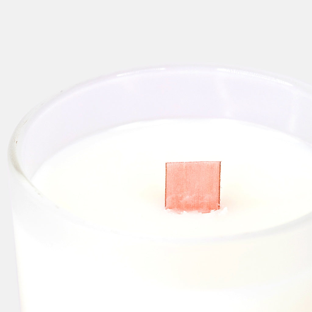 close up of pink wood wick in candle