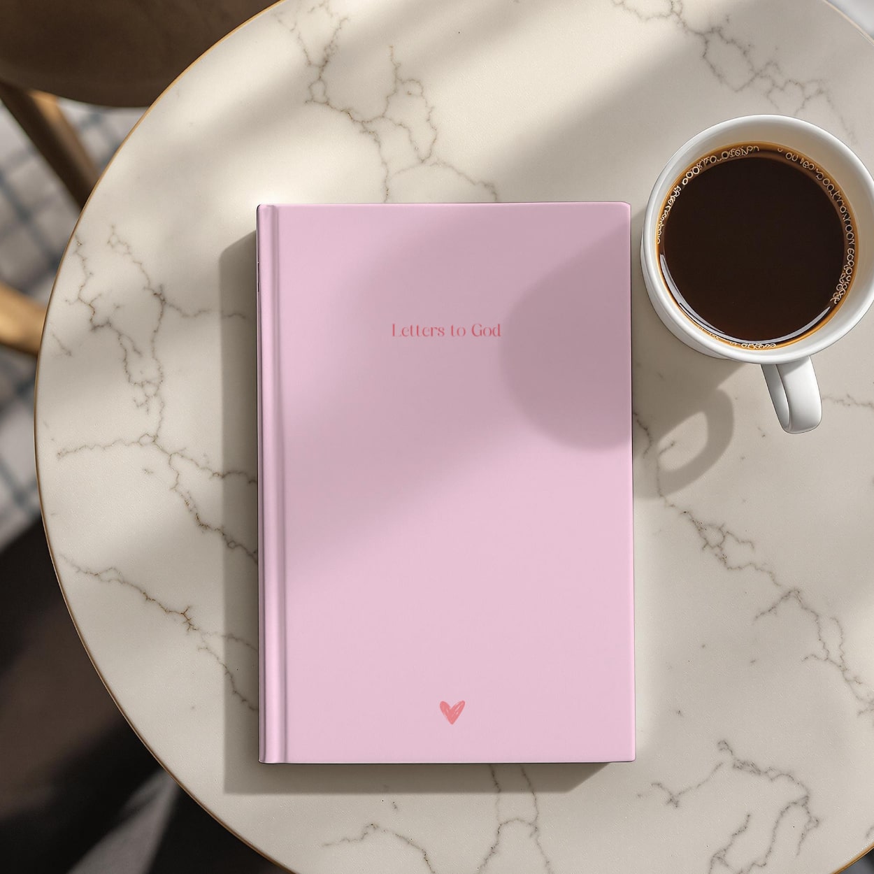 Blush pink faith journal beside a morning coffee cup, showcasing peaceful devotional setting