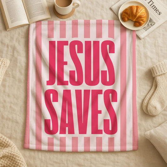 Jesus Saves striped blanket in pink and white with coral pink stripes on soft blush background, bold fuchsia text saying Jesus Saves, double-sided Christian throw blanket