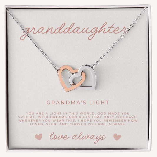 Necklace with interlocking heart pendants with a message card that reads 'granddaughter, grandma's light', faith based gift