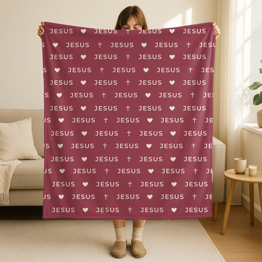 Jesus name blanket in deep burgundy wine color with repeating Jesus text pattern, small hearts and crosses in cream white, double-sided minimalist Christian throw blanket