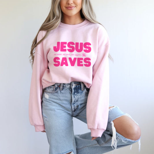 Jesus Saves Christian sweatshirt in pale pink with hot pink bold lettering, women's faith-based crewneck apparel