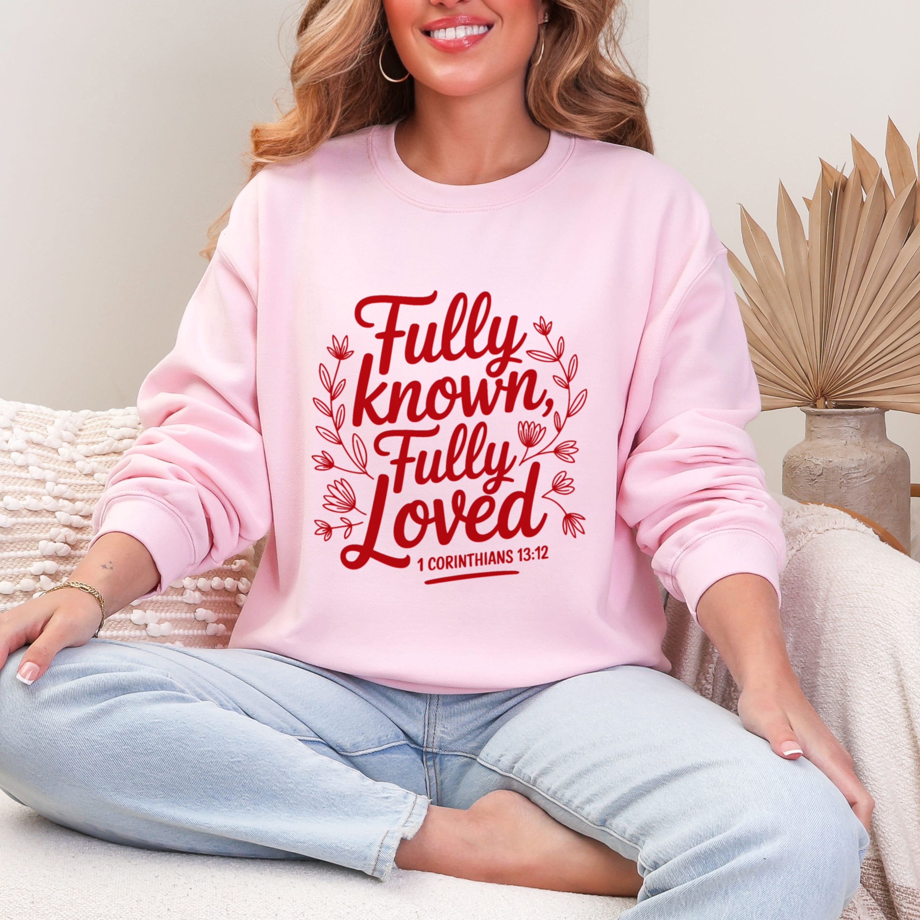 Light pink Fully Known Fully Loved sweatshirt with red floral typography - 1 Corinthians 13:12 Christian crewneck