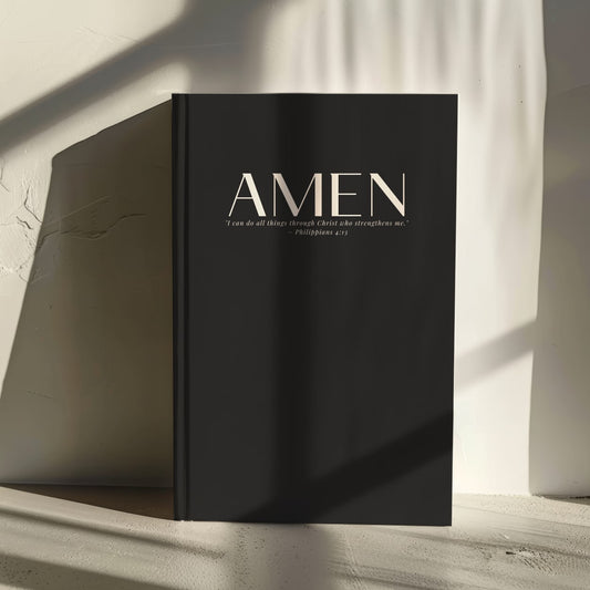 Black luxury hardcover journal with 'Amen' and Philippians 4:13 on the cover, in an elegant minimalist font.
