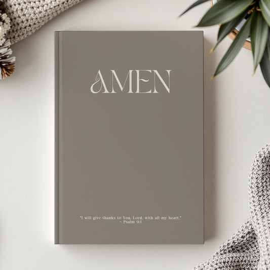 Moss gray faith journal resting on white table, capturing the journal's luxurious matte finish and elegant design