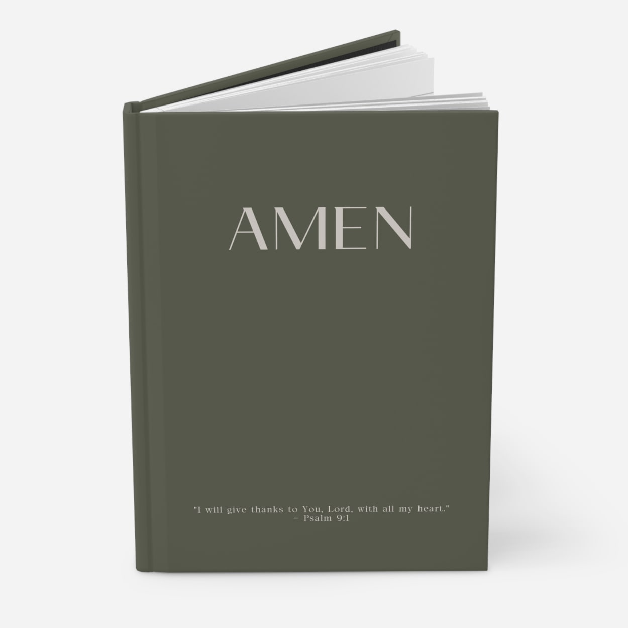 Olive green AMEN journal standing upright, highlighting elegant cover and sophisticated profile against neutral background