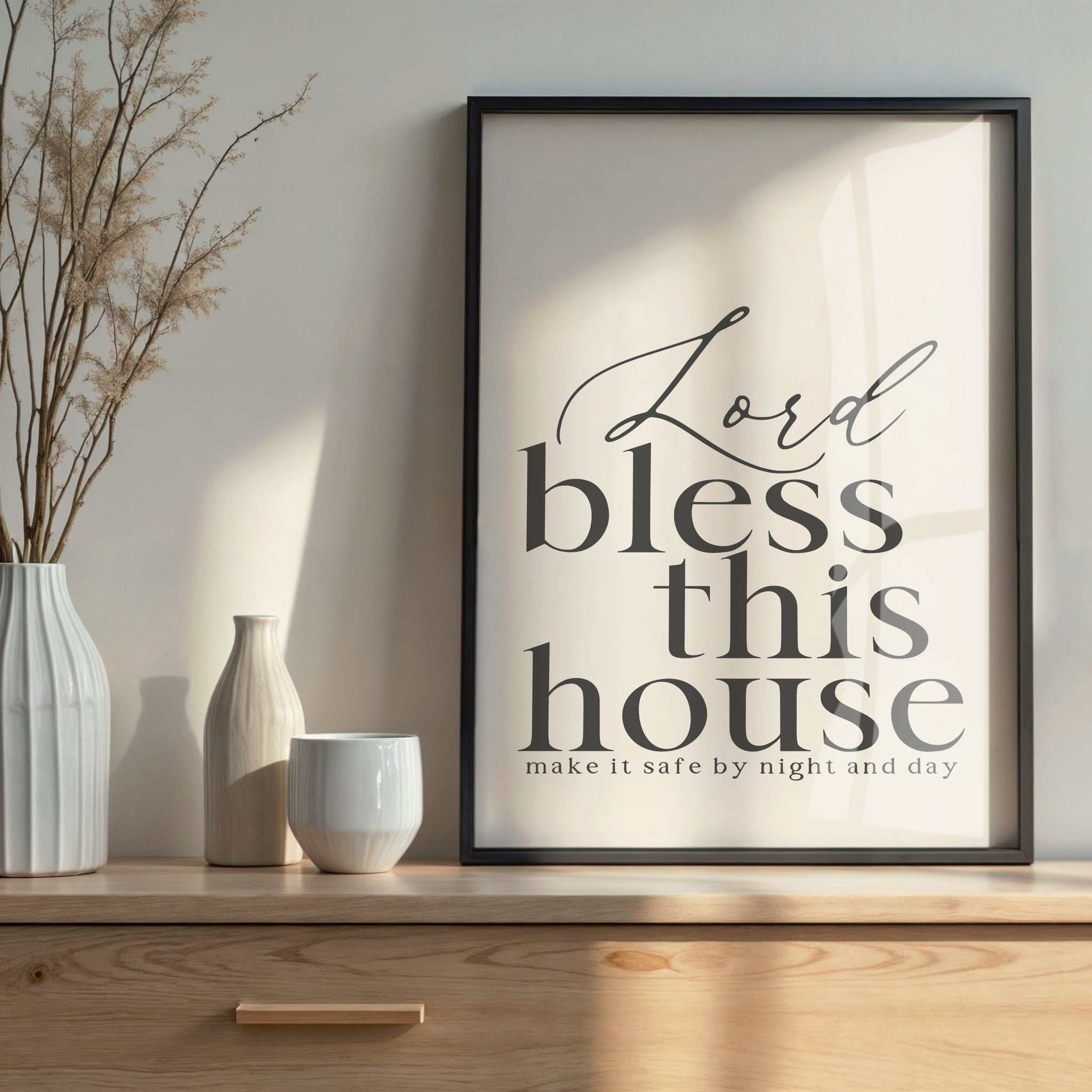 'Lord bless this house' elegant typography print in black frame, against a neutral wall for spiritual home protection.