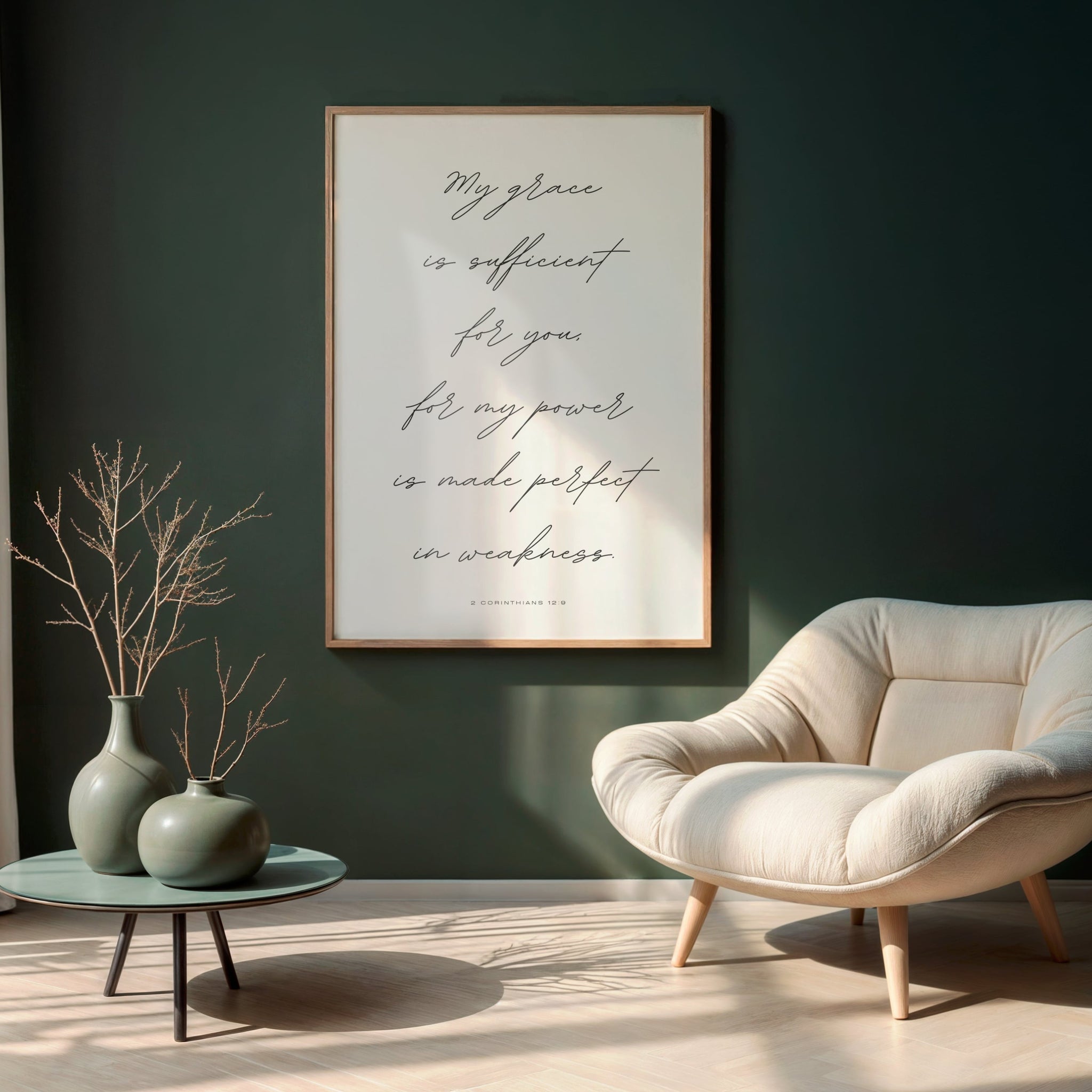 Elegant script typography print of '2 Corinthians 12:9: My grace is sufficient for you' in wooden frame on living room wall