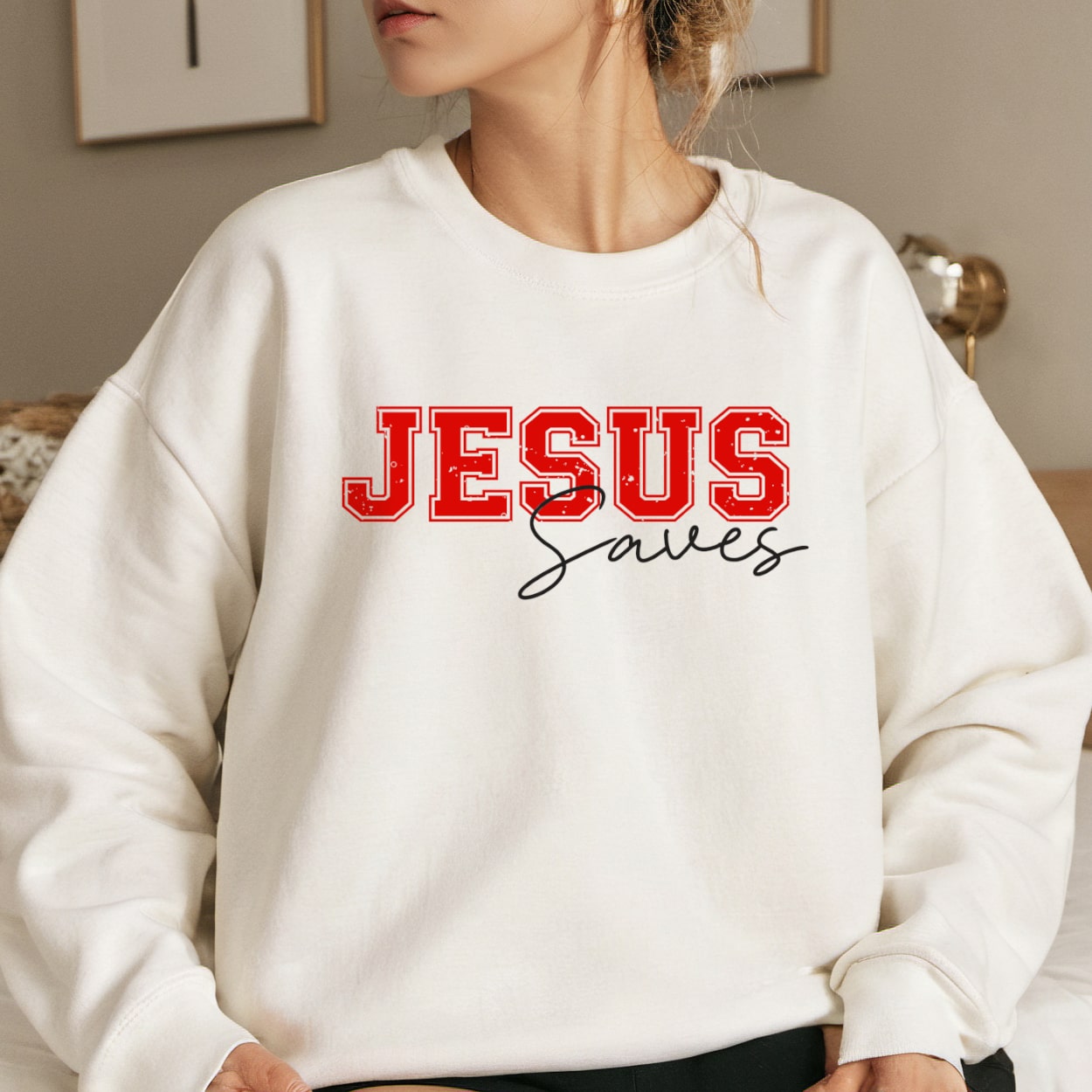 White Christian crewneck sweatshirt with Jesus Saves in bold red college-style font
