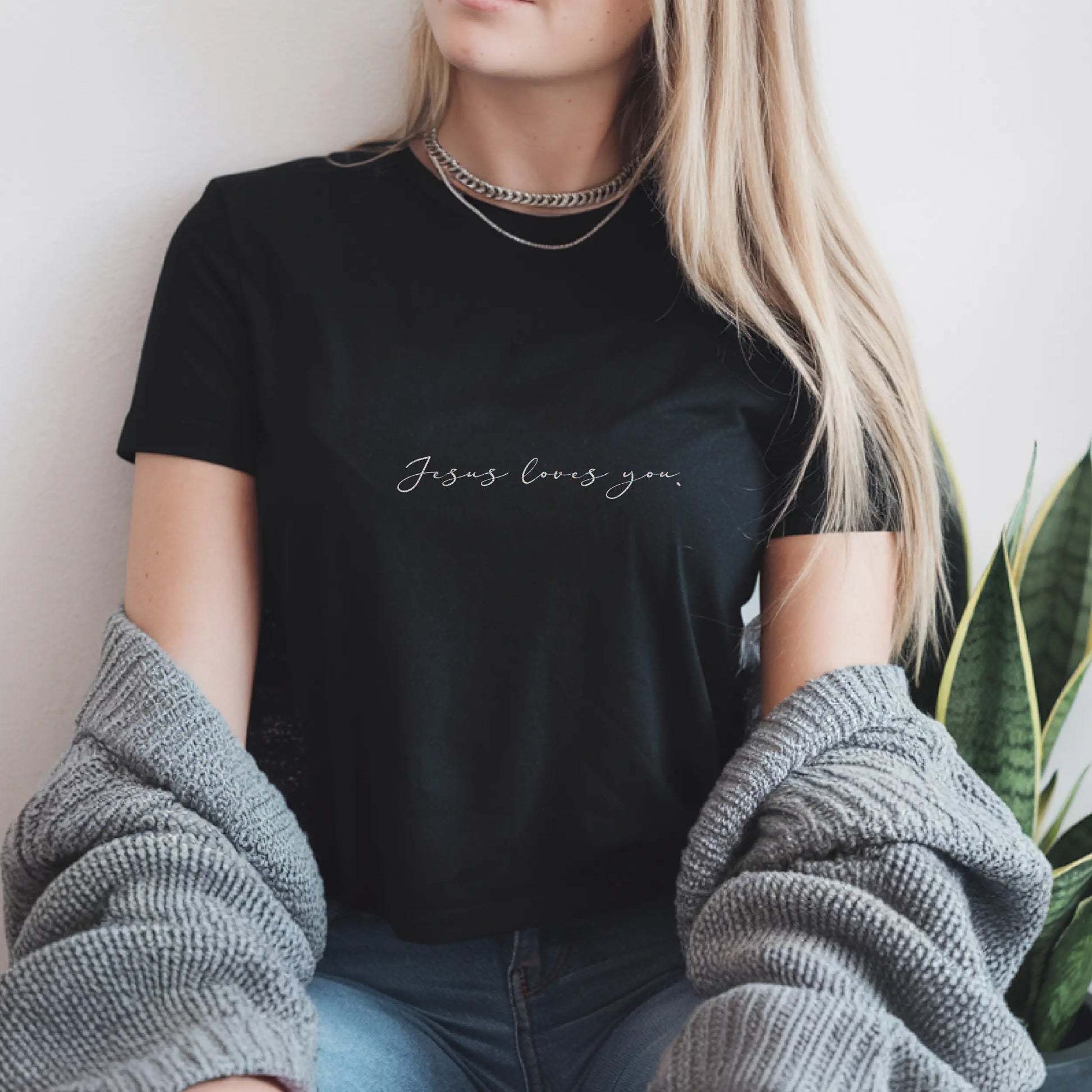 Minimalist black faith-based T-shirt with "Jesus Loves You." in elegant script