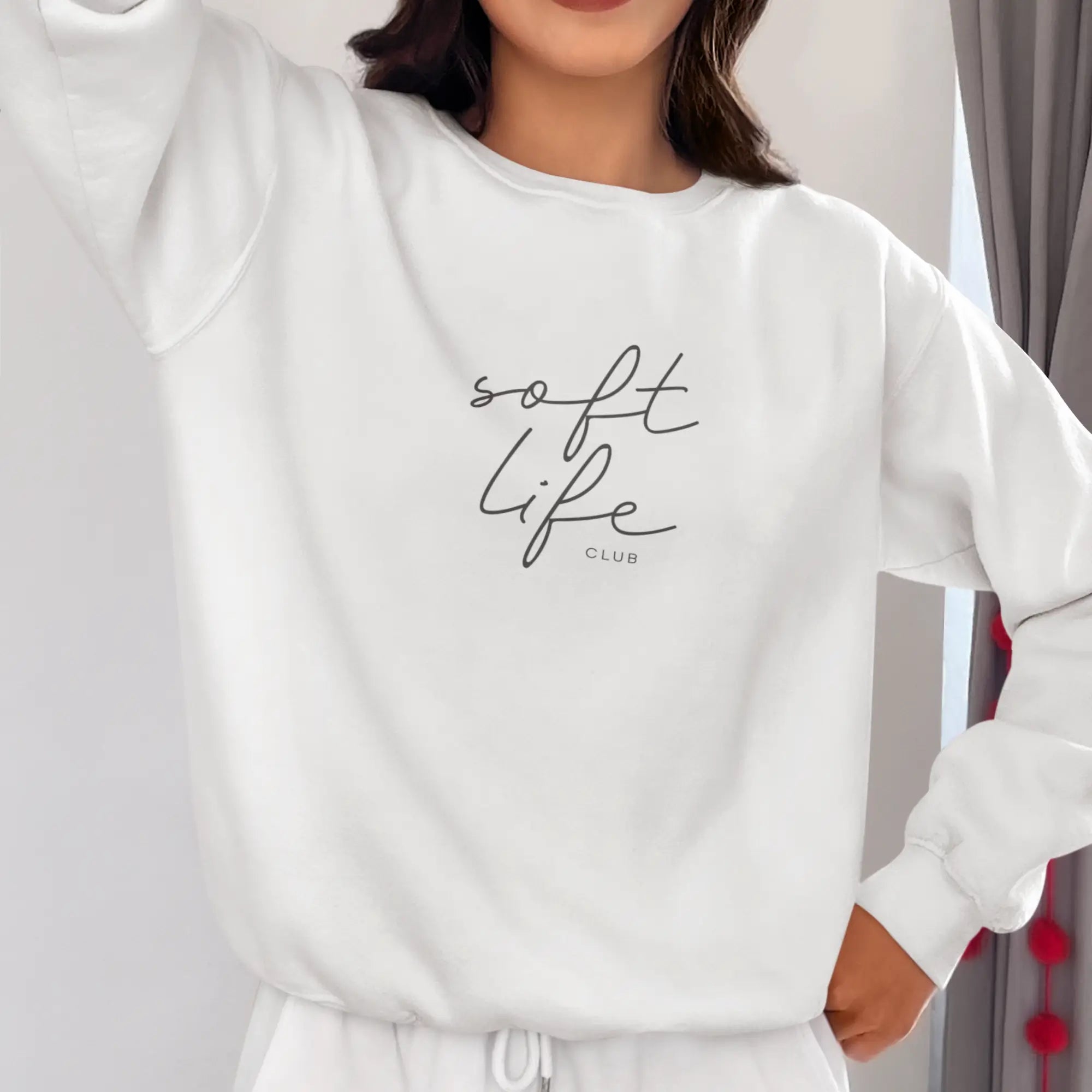 Ultra-soft women's white sweatshirt with 'Soft Life Club' text, perfect for self-care loungewear