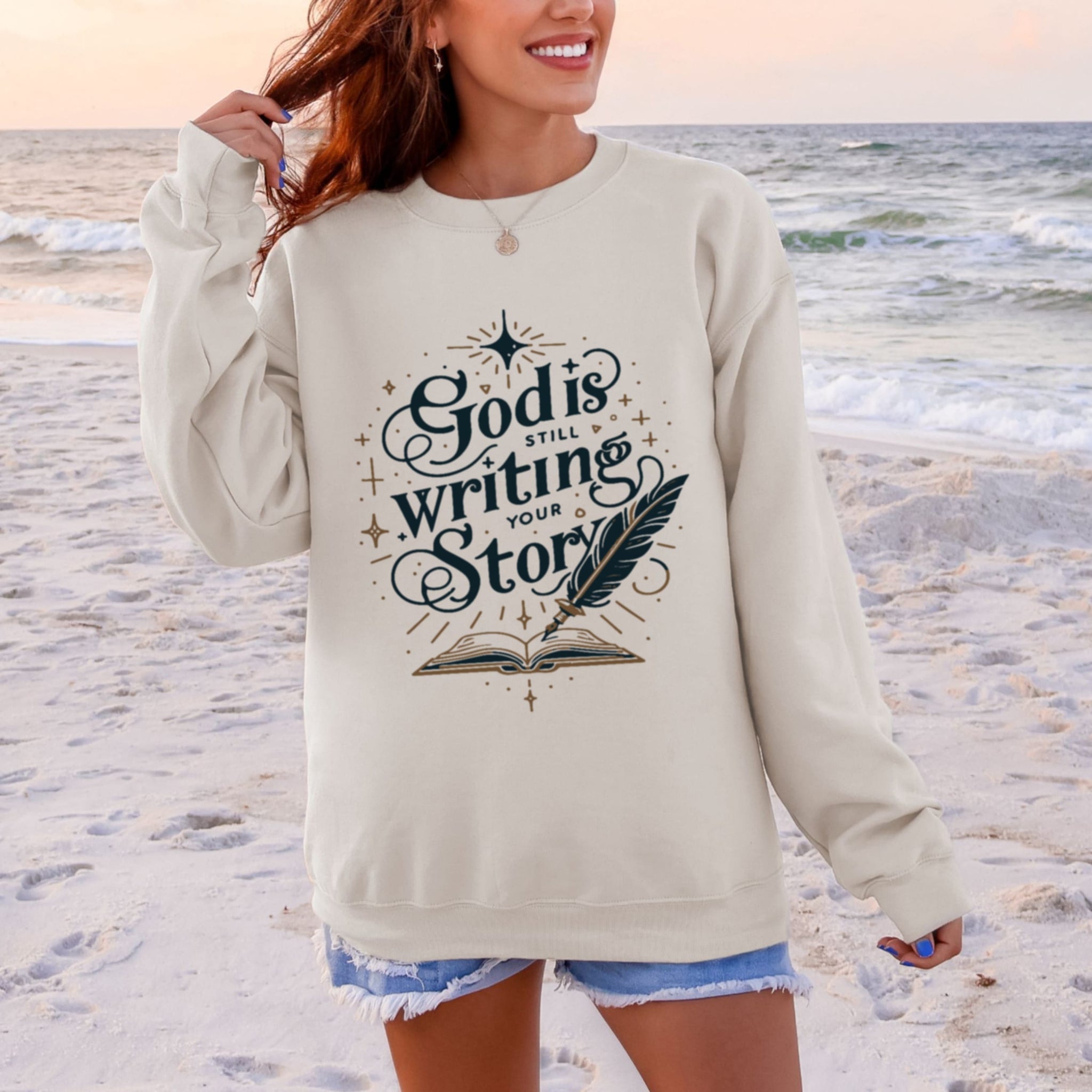 Beige God Is Still Writing Your Story sweatshirt, inspirational Christian crewneck with book and feather design