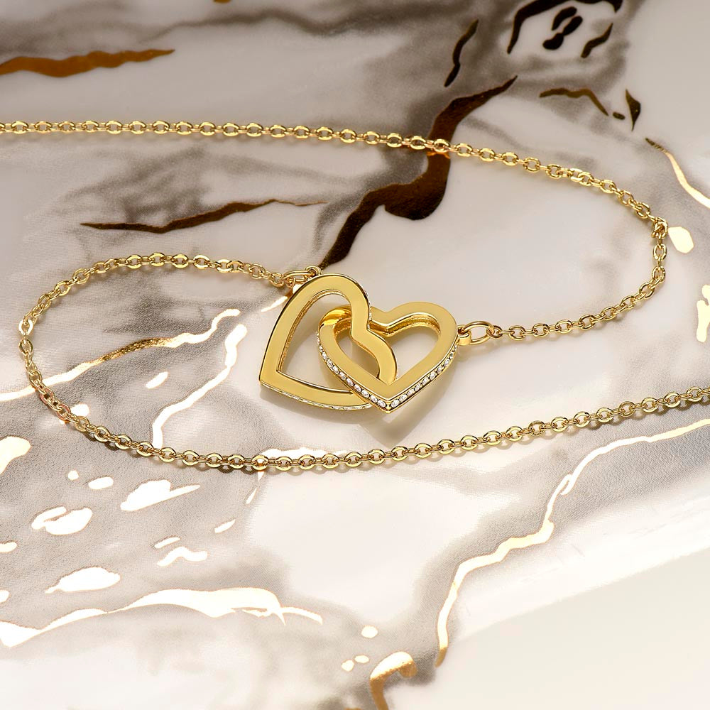 close up of gold interlocking hearts necklace gift.