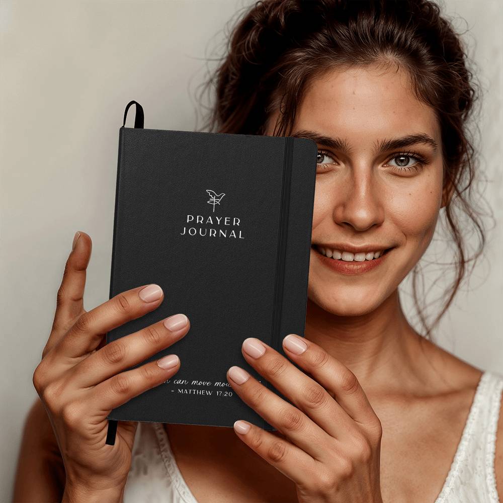 Black elegant prayer journal with bible quote 'Faith can move mountains' written on the front.