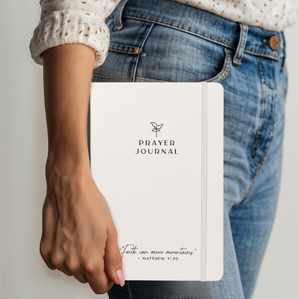 A faith-inspired prayer journal being held, ideal for daily devotionals and personal reflection.