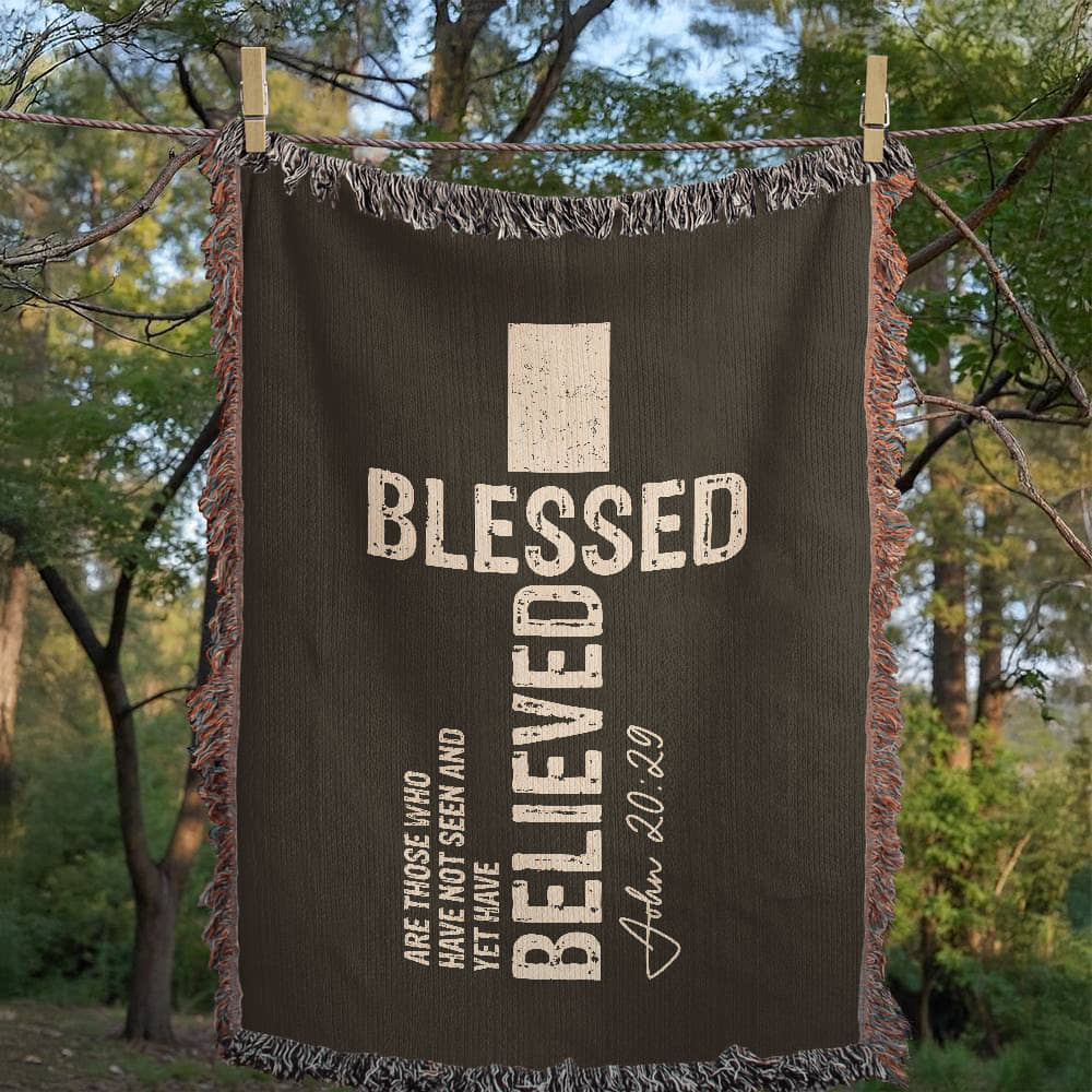 Christian woven blanket hanging on a washing line.