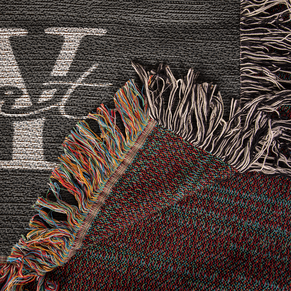 close up of 100% cotton yarn woven blanket with faith inspired quote