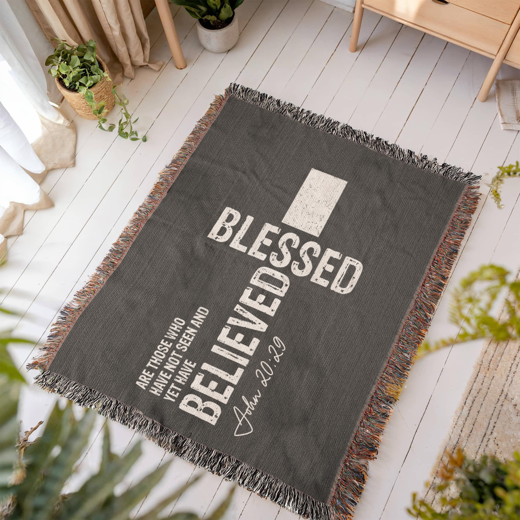 Christian woven blanket laid out on a floor, adding warmth and faith to any home decor.