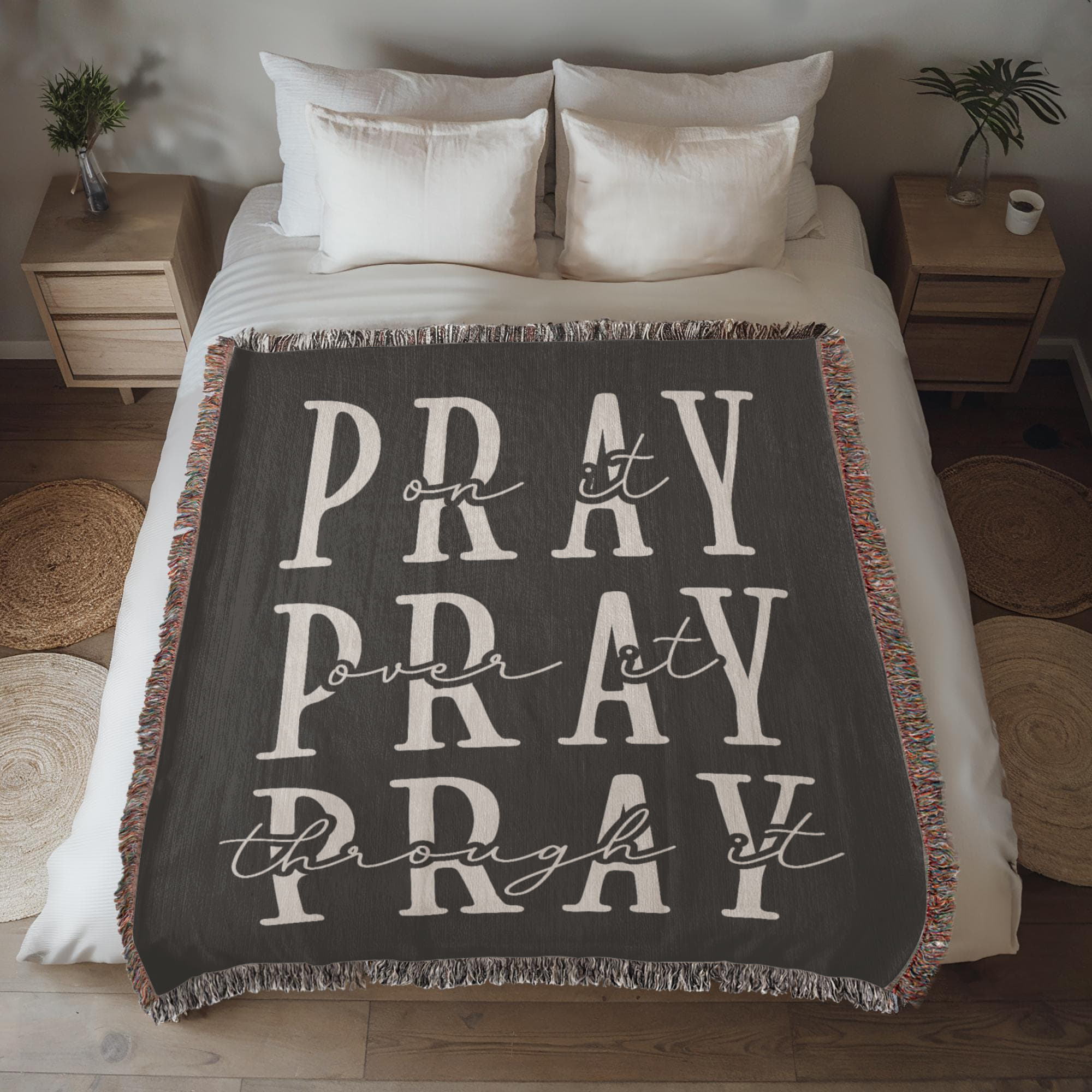 A soft, dark gray woven blanket with the words 