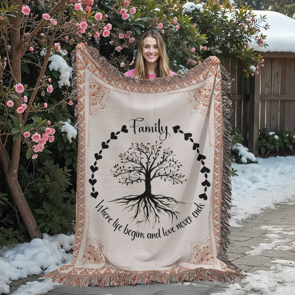 family heirloom blanket with a sweet quote 'Where life begins and love never ends'. Being held by a woman to show.