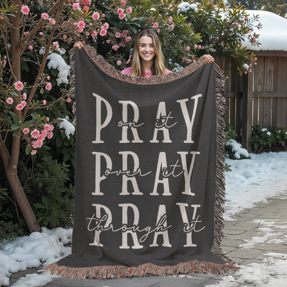 A faith-inspired woven blanket with the words 