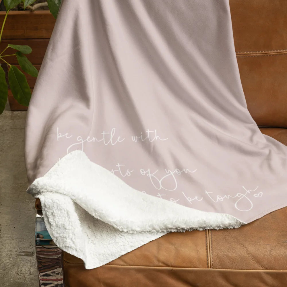 Luxe sherpa fleece blanket throw on a chair showing both sides of the soft fabric, in pink with quote
