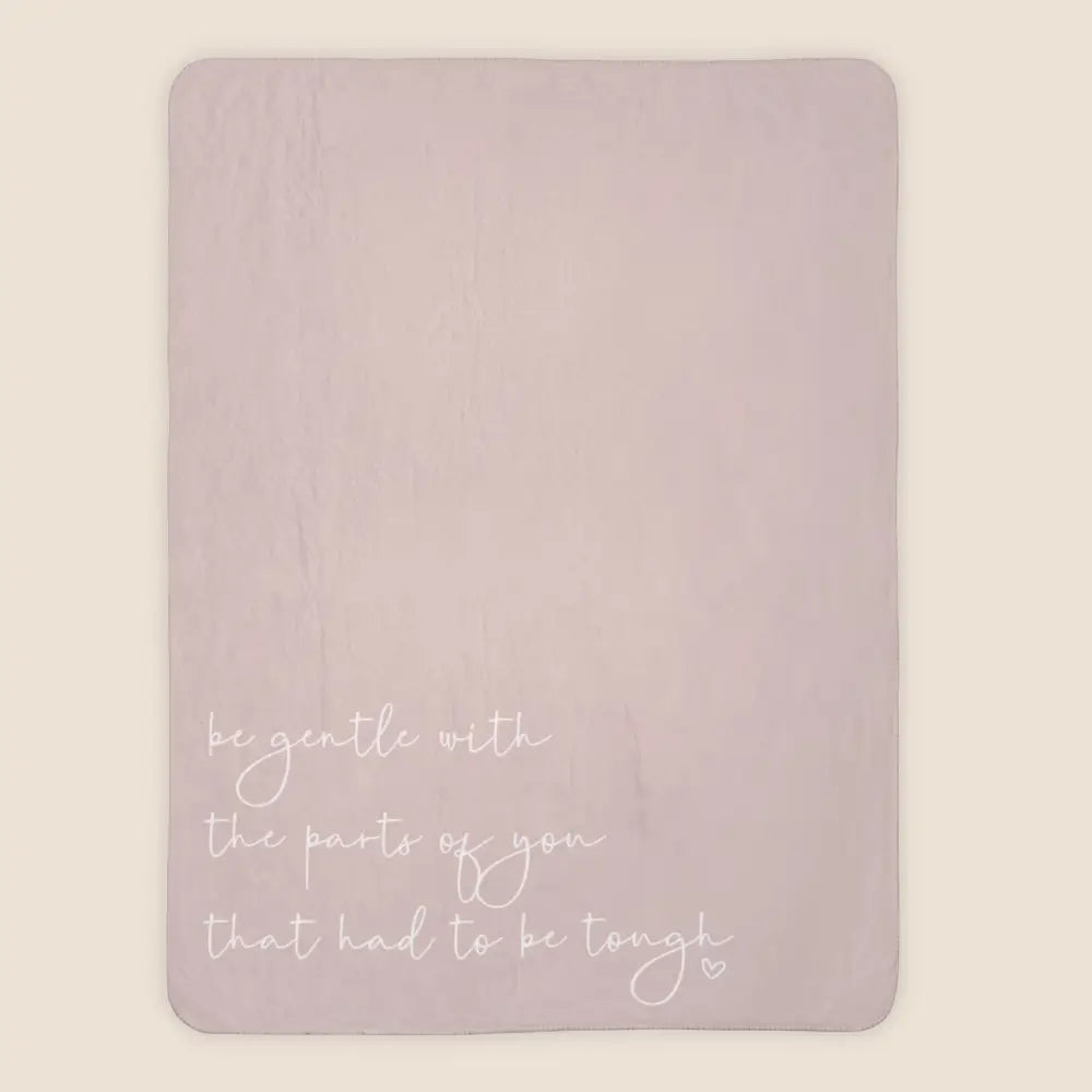 Comforting extra large pink sherpa throw with 'be gentle with the parts of you that had to be tough' quote
