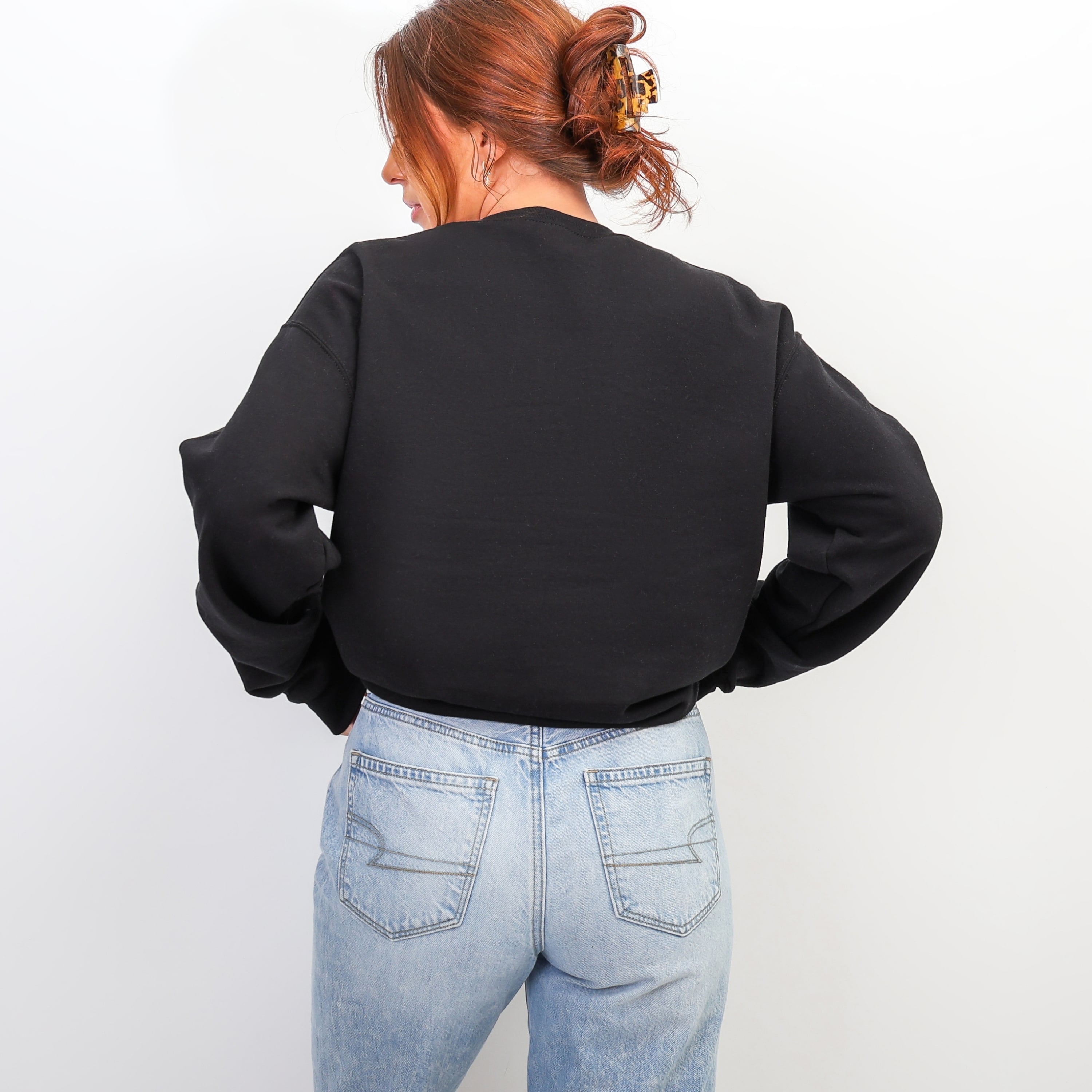 Back view of black YAHWEH oversized sweatshirt - minimalist Christian crewneck for women