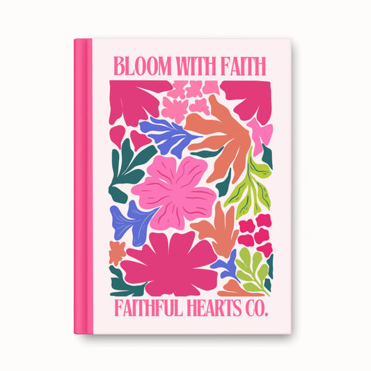Colorful floral hardback journal with “Bloom With Faith” text with Faithful Hearts Co. branding