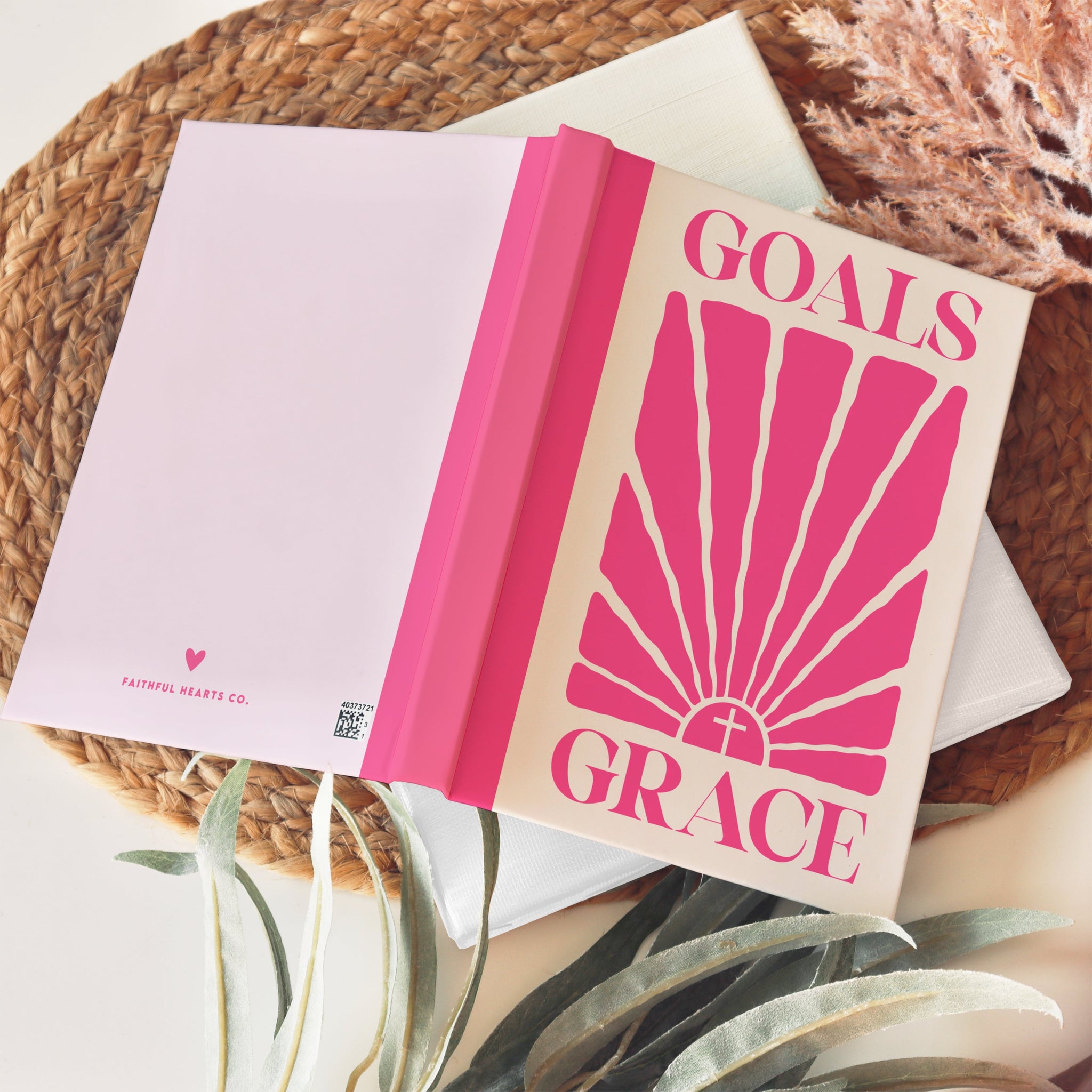 Soft pink spiritual goals journal with sunbeam design and “Goals Grace” cover text