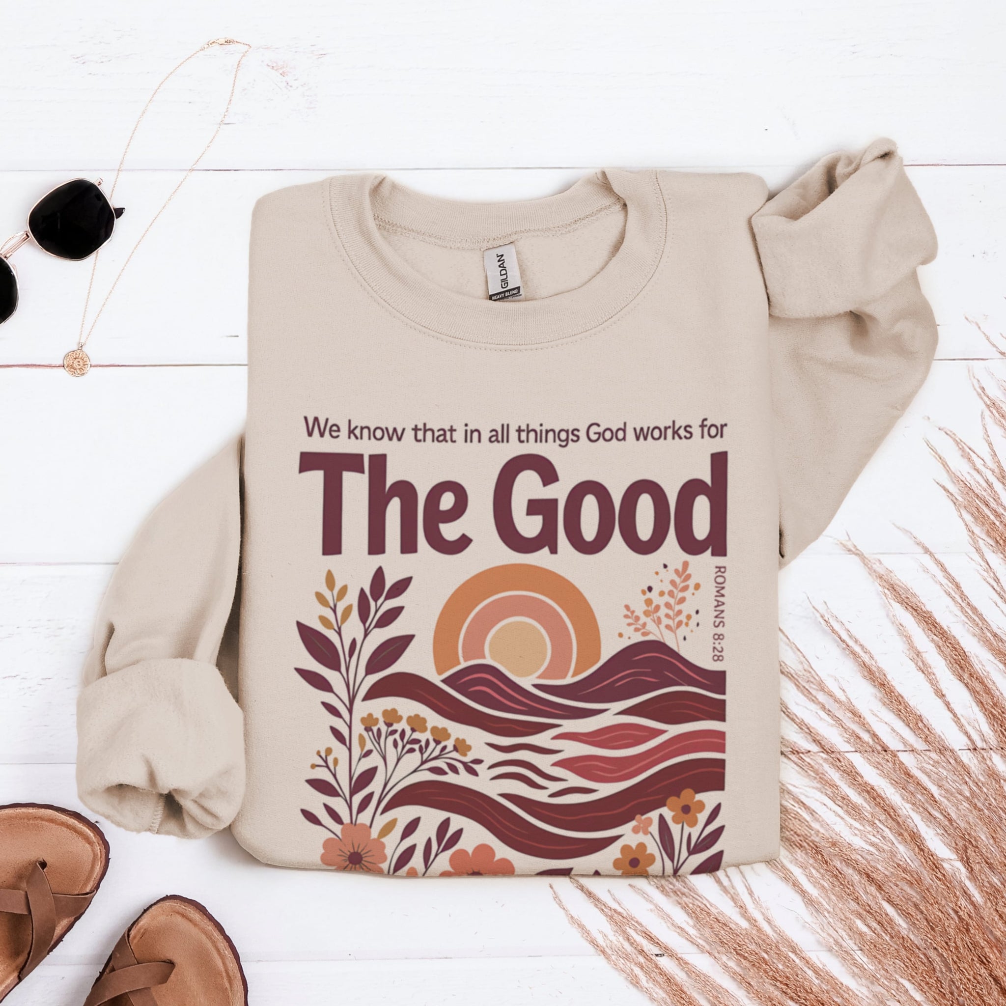 Beige Romans 8:28 God Works For The Good sweatshirt flat lay - artistic boho Christian scripture apparel for women