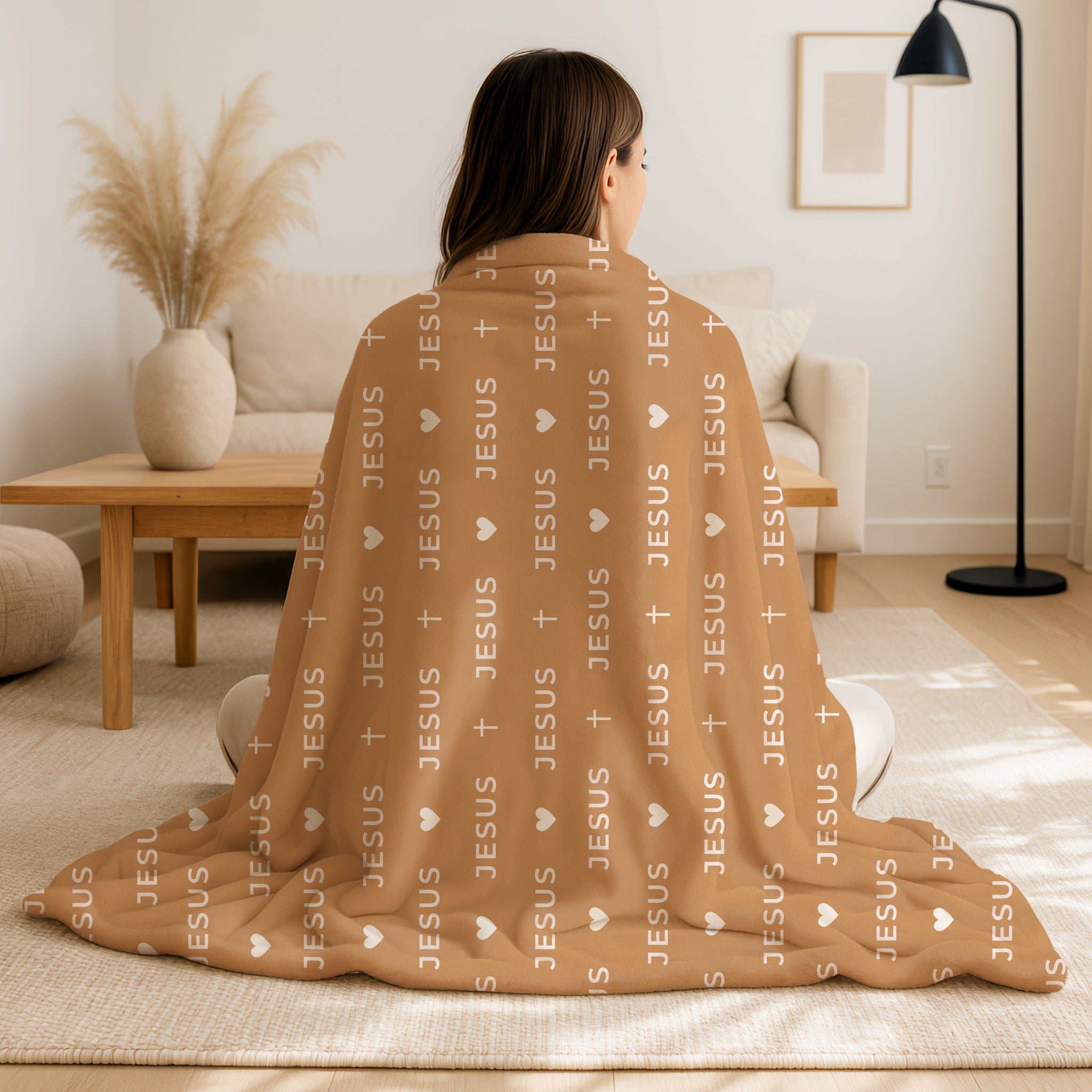 Tan caramel colored JESUS blanket with simple light cream typography