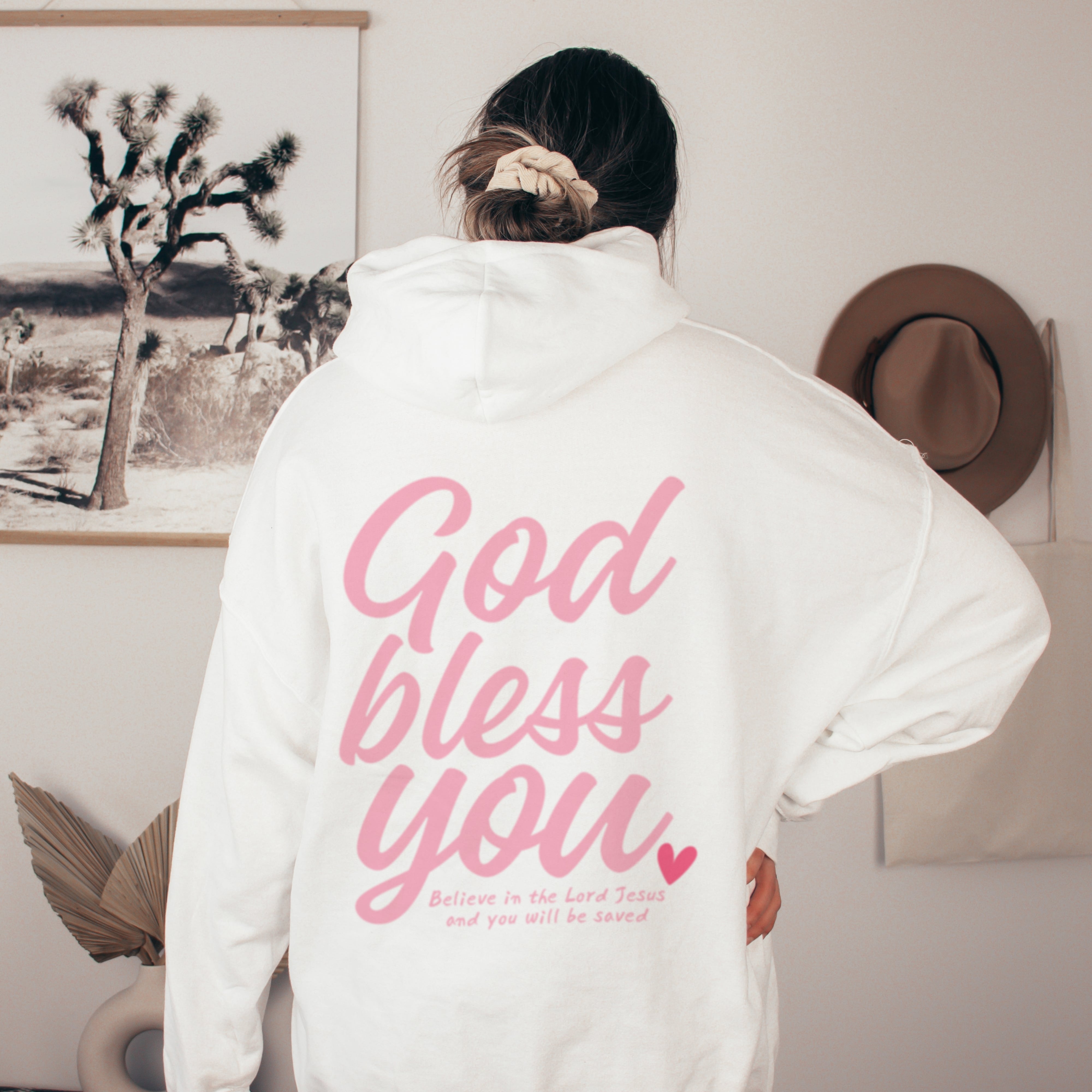 Back of white Christian hoodie with pink God Bless You and scripture message on the back