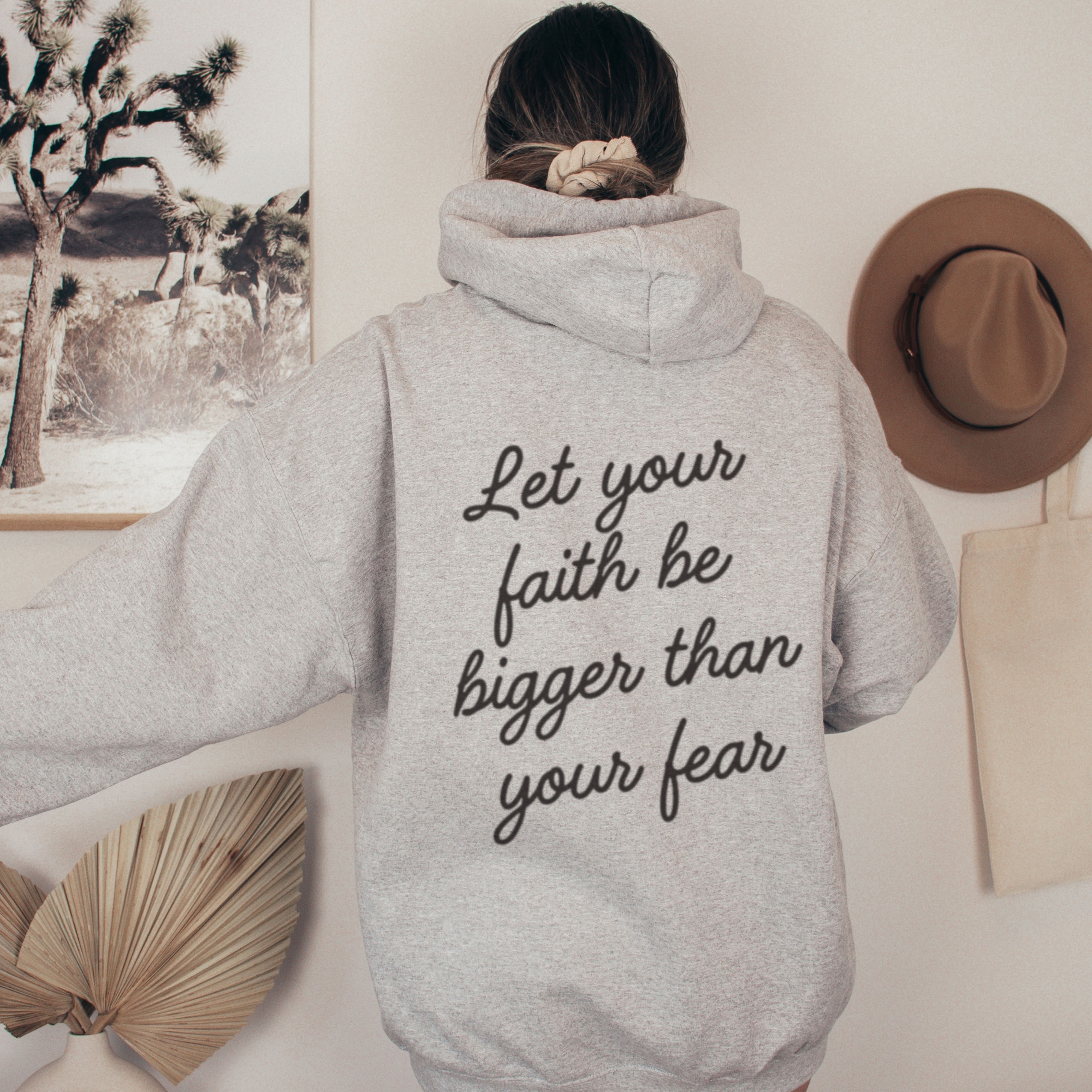 Grey Christian hoodie with Let your faith be bigger than your fear quote on the back