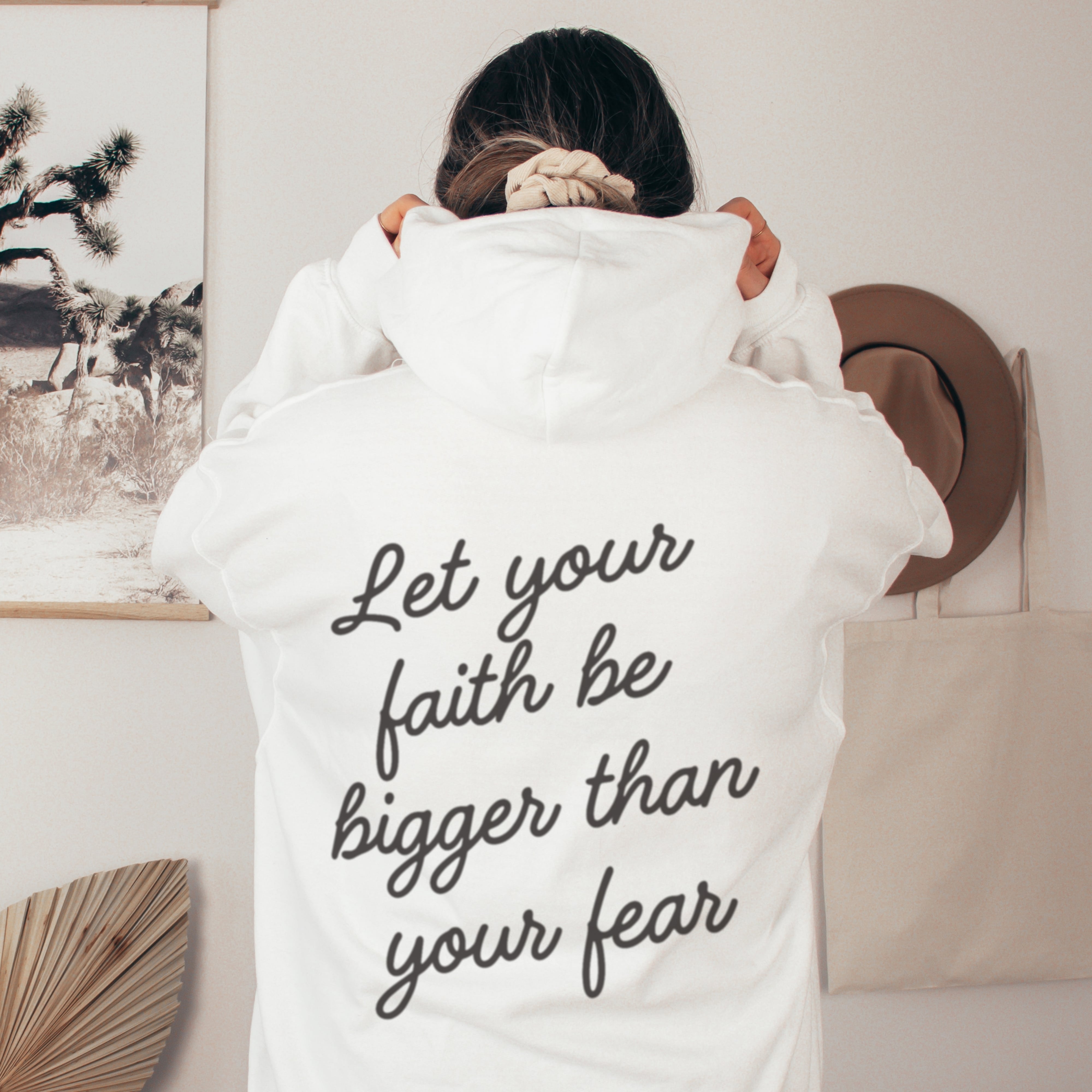 Back of white Christian hoodie with Let your faith be bigger than your fear quote, inspirational faith-based clothing for women