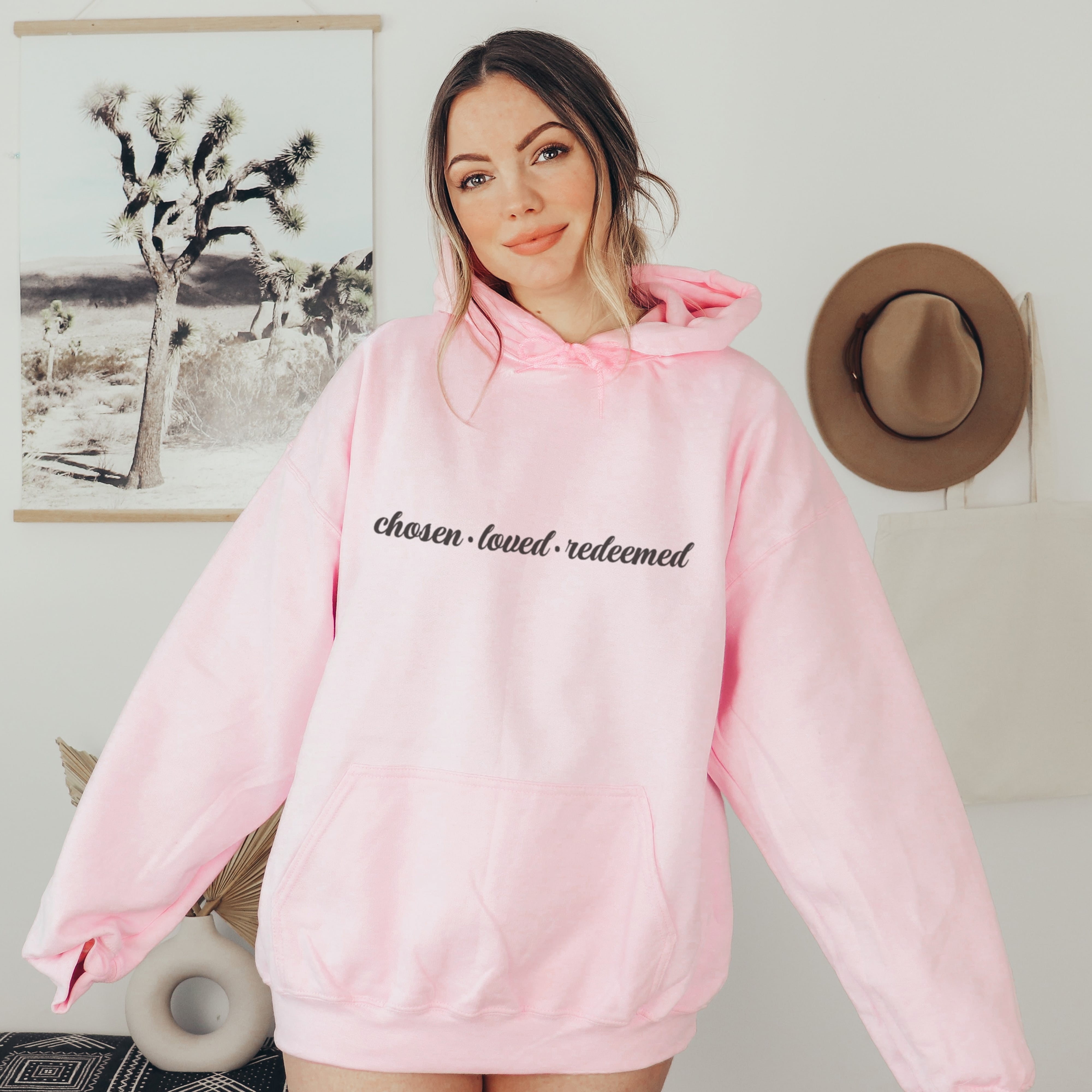 Woman in pink chosen loved redeemed hoodie, cozy Christian faith-based sweatshirt for women
