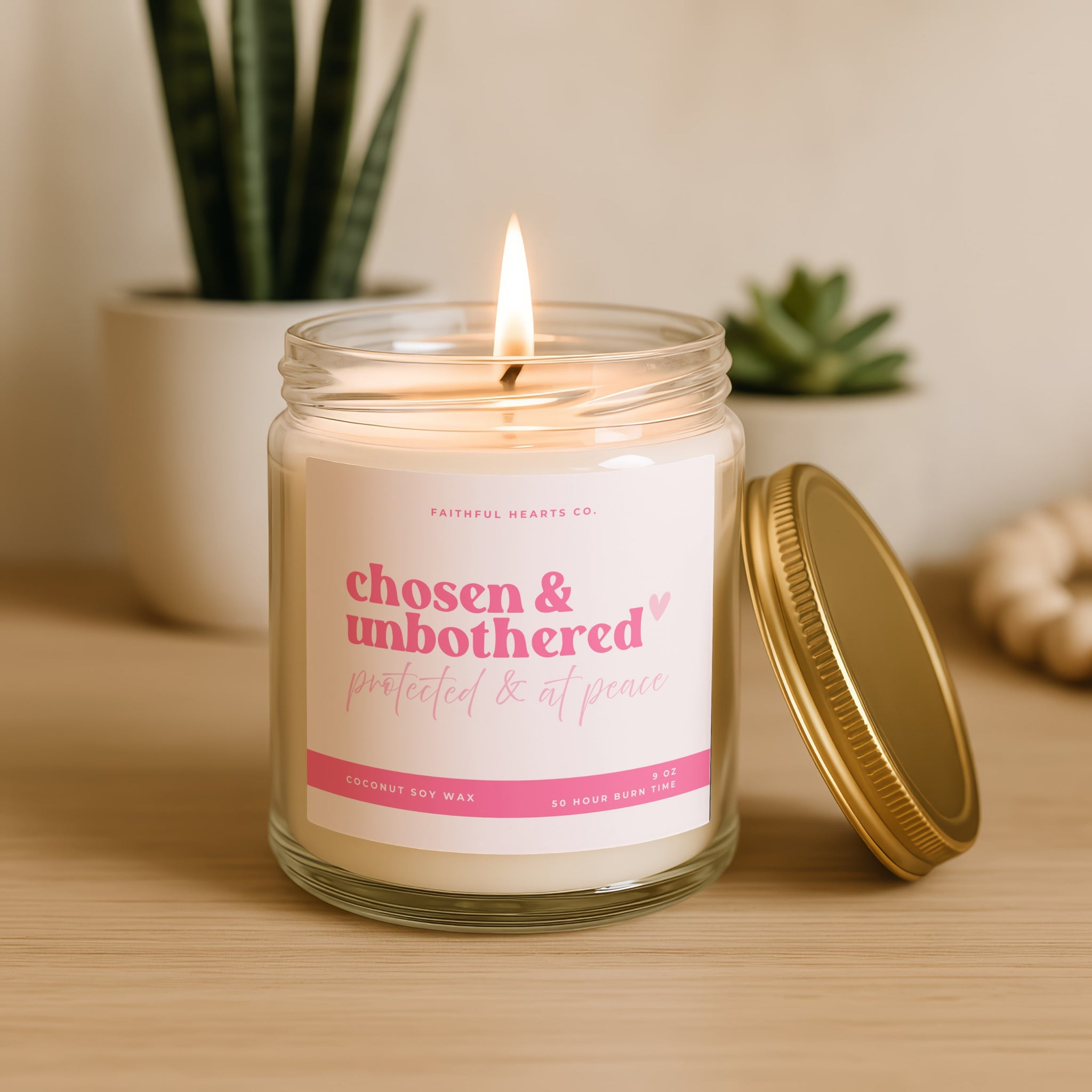 Chosen and unbothered faith candle in clear glass jar with pink label and gold lid, hand poured coconut apricot wax candle protected and at peace