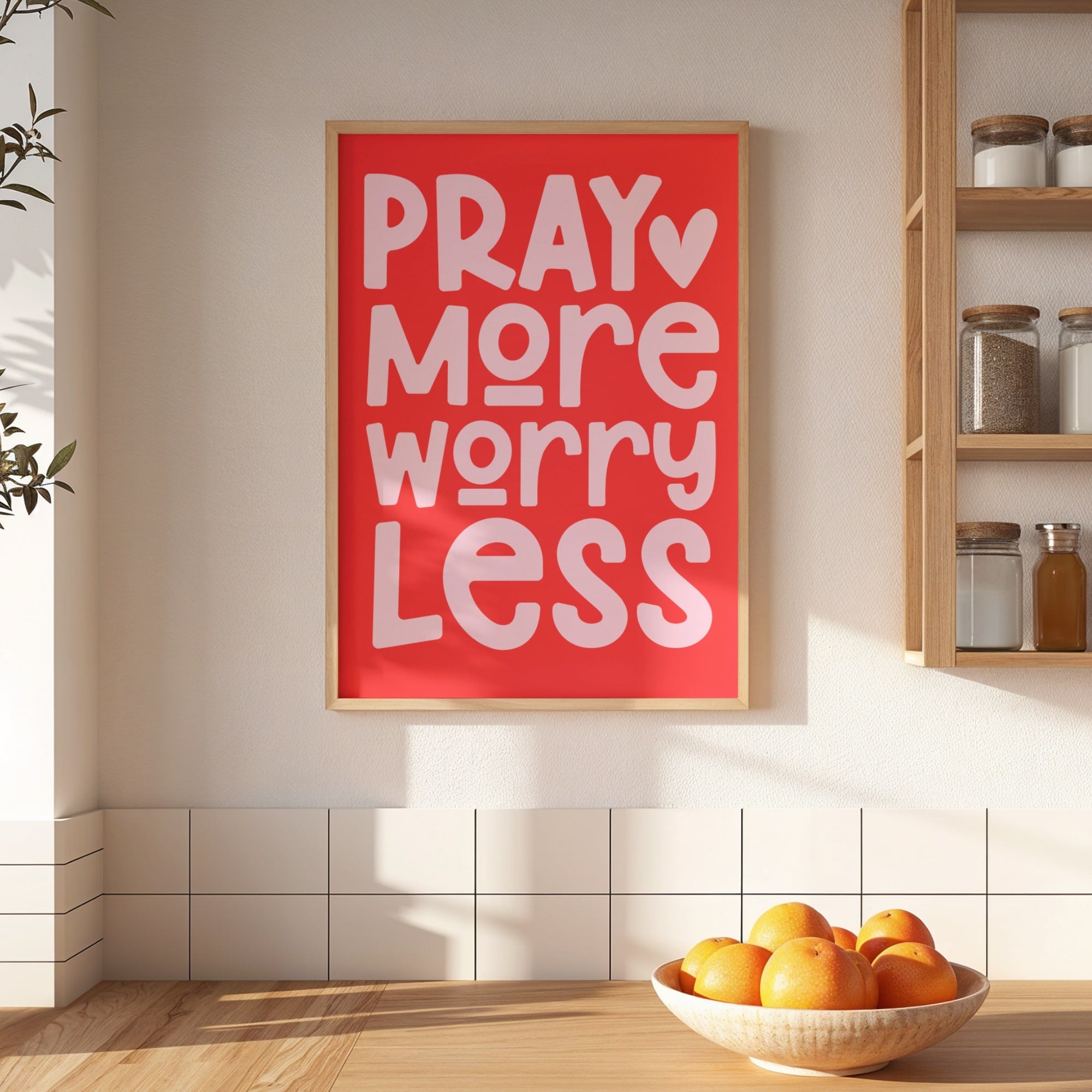 Red framed poster with 'Pray More Worry Less' text in a kitchen setting.
