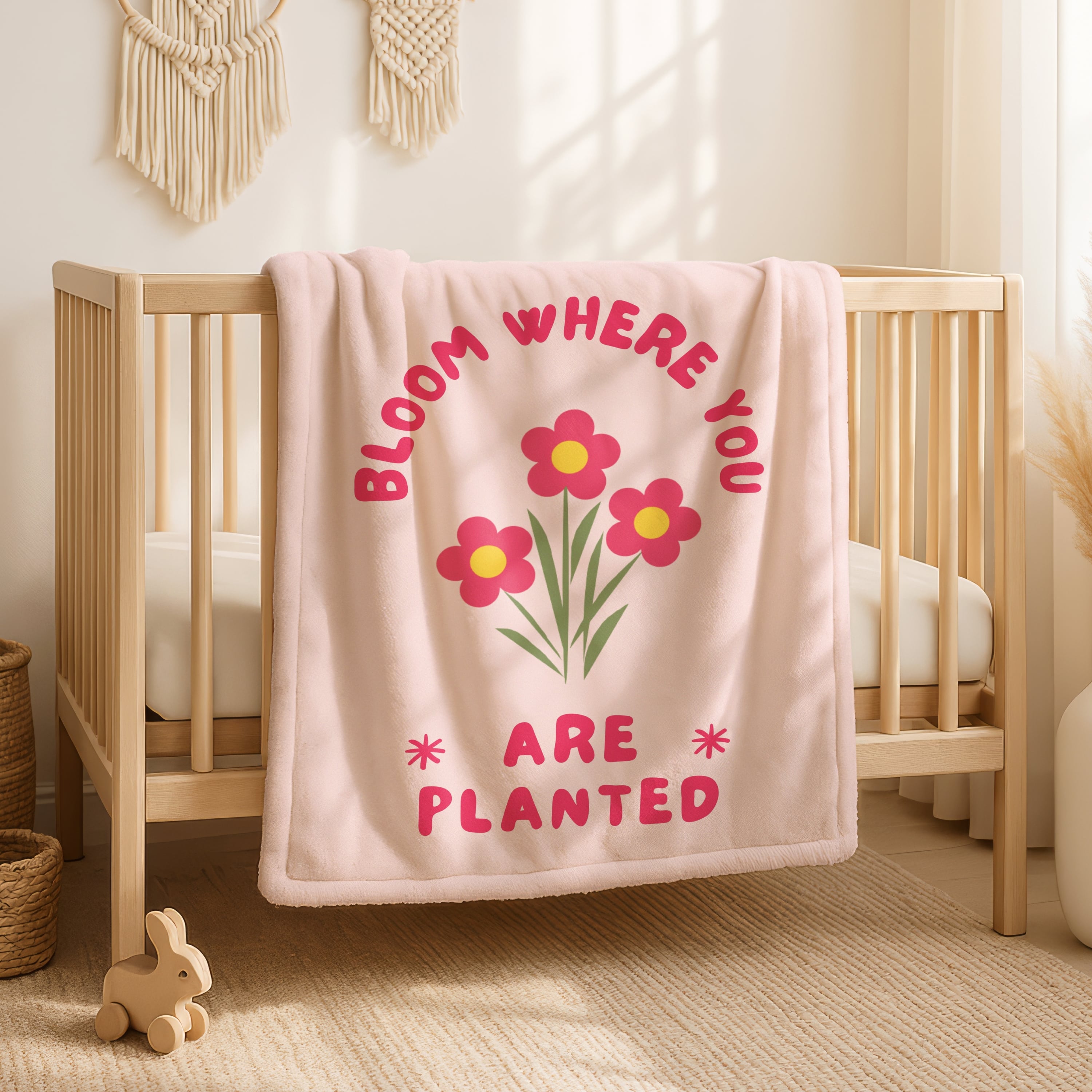 Faith-based throw blanket in soft pink with encouraging Bloom Where You Are Planted quote