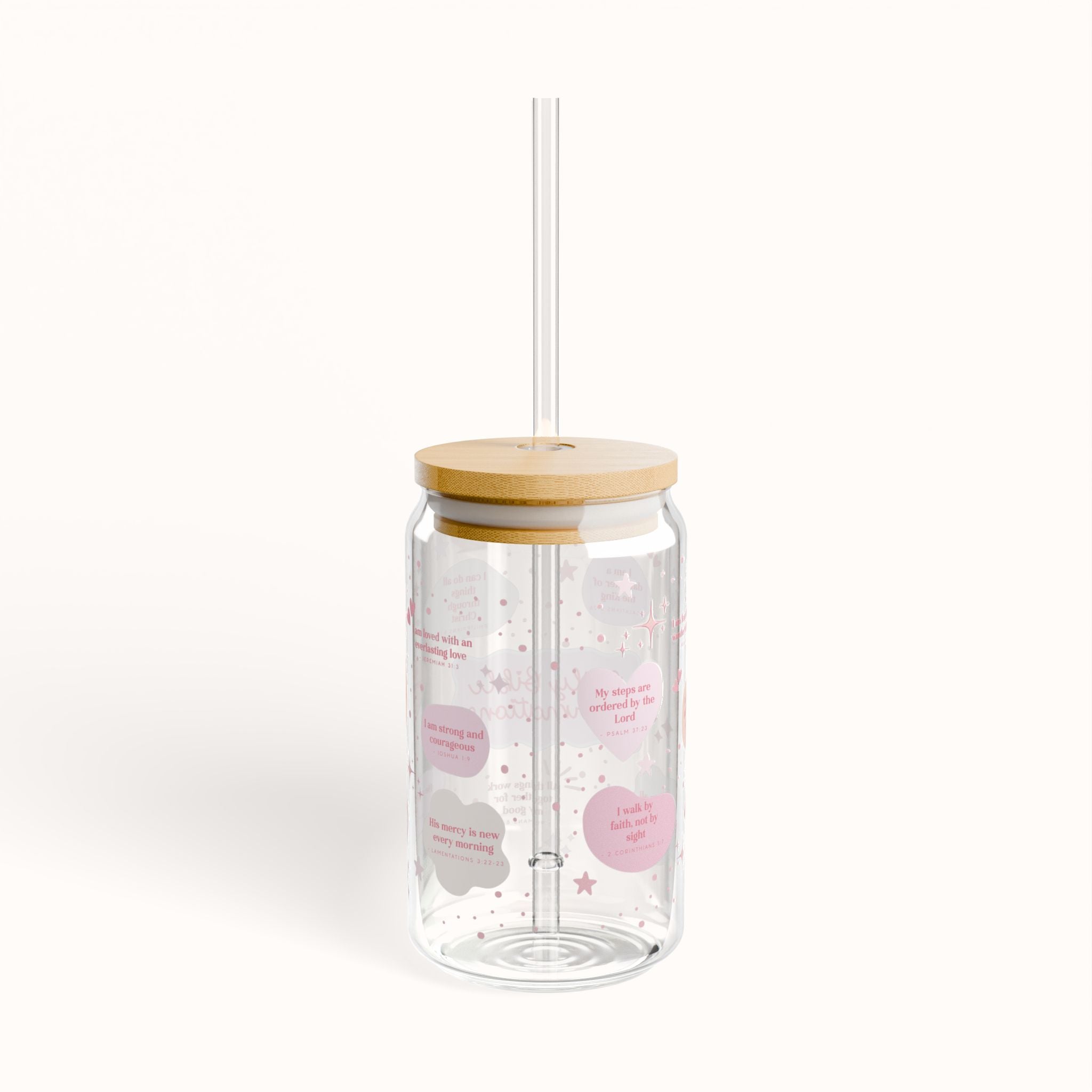 Clear tumbler with wooden lid and straw on a white background