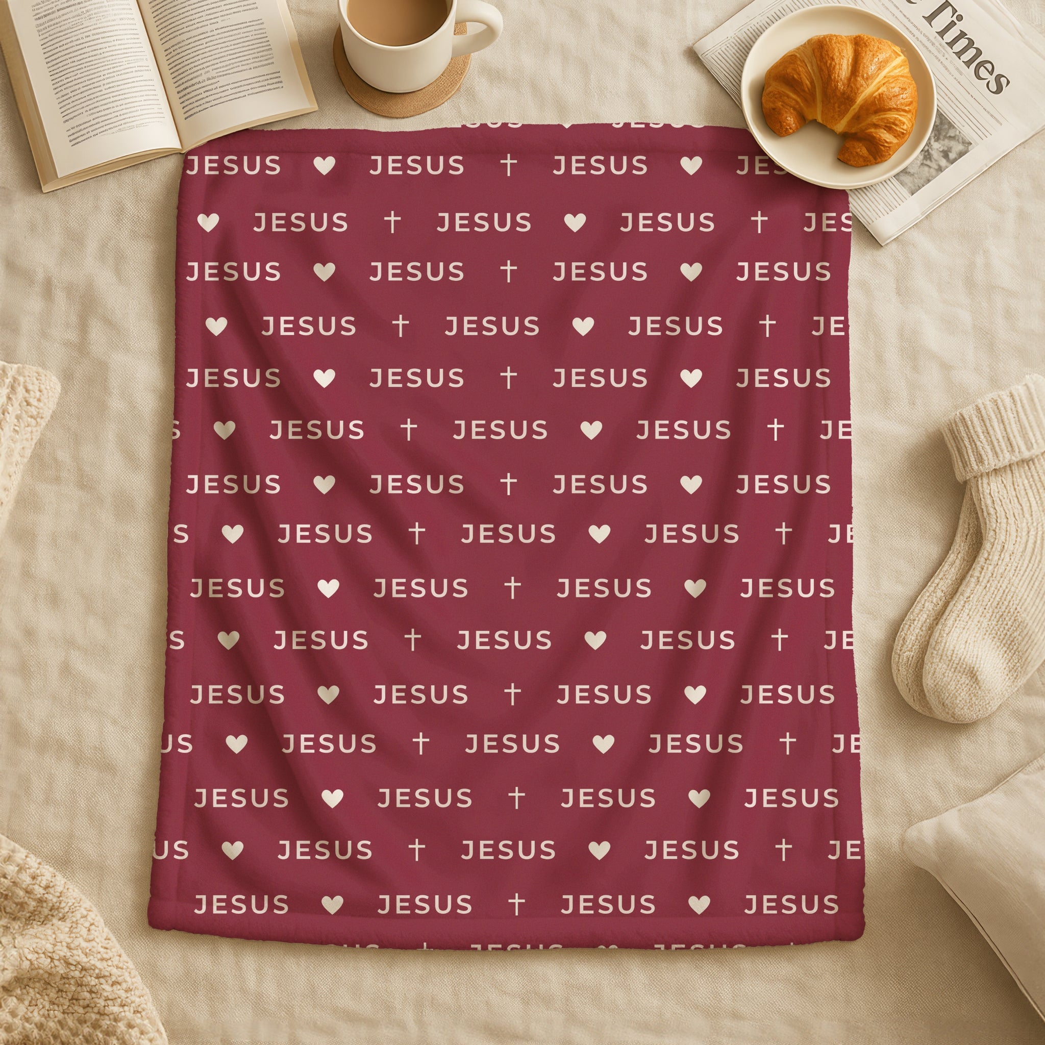 Burgundy blanket with cream JESUS lettering in minimalist modern design