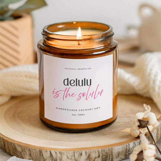 Amber glass Delulu is the Solulu manifestation candle by Faithful Hearts, fun self belief and mindset gift for women embracing soft girl energy.