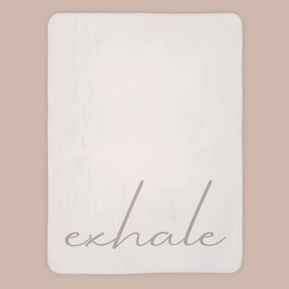 Neutral extra large sherpa fleece blanket with calming exhale script on a plain background