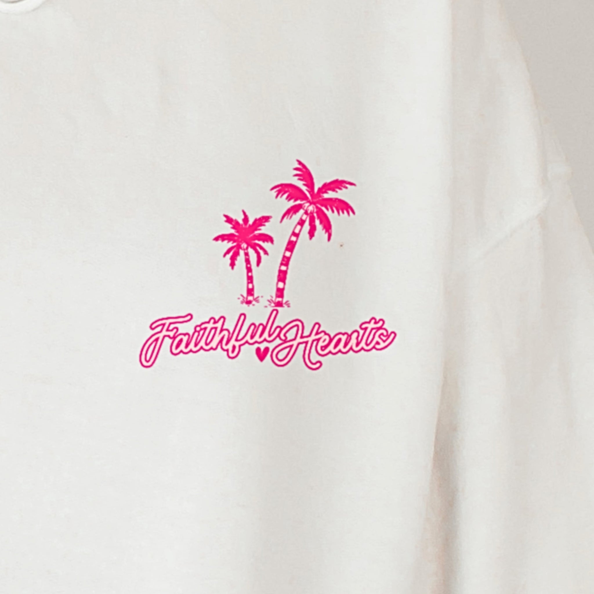 White hoodie with pink palm trees and 'Faithful Hearts' text on a white background