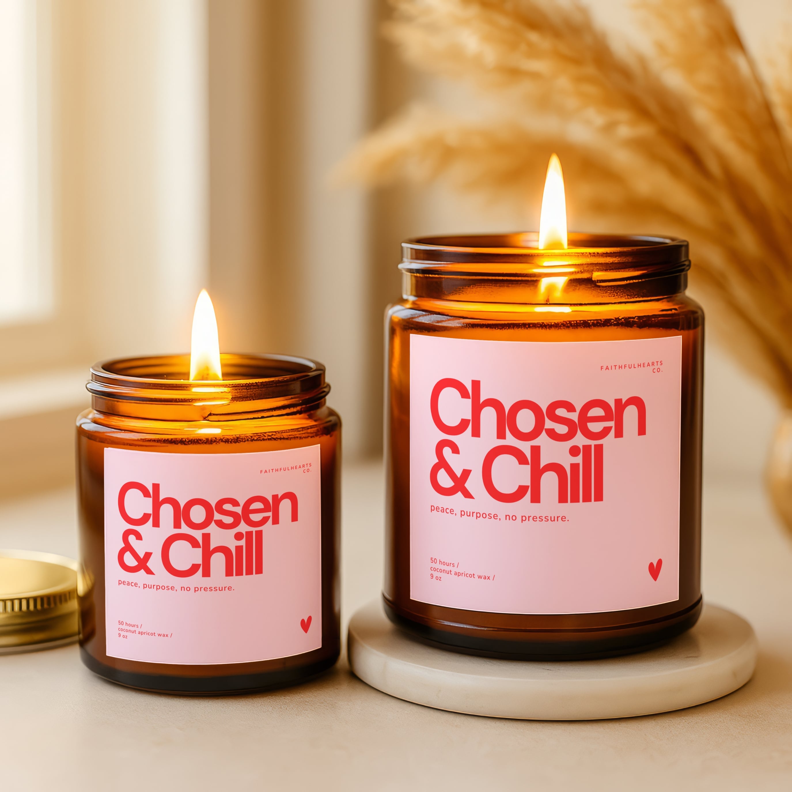 Chosen and Chill scented candle, amber glass with minimalist pink and red label design, hand poured coconut apricot wax, made in the USA.