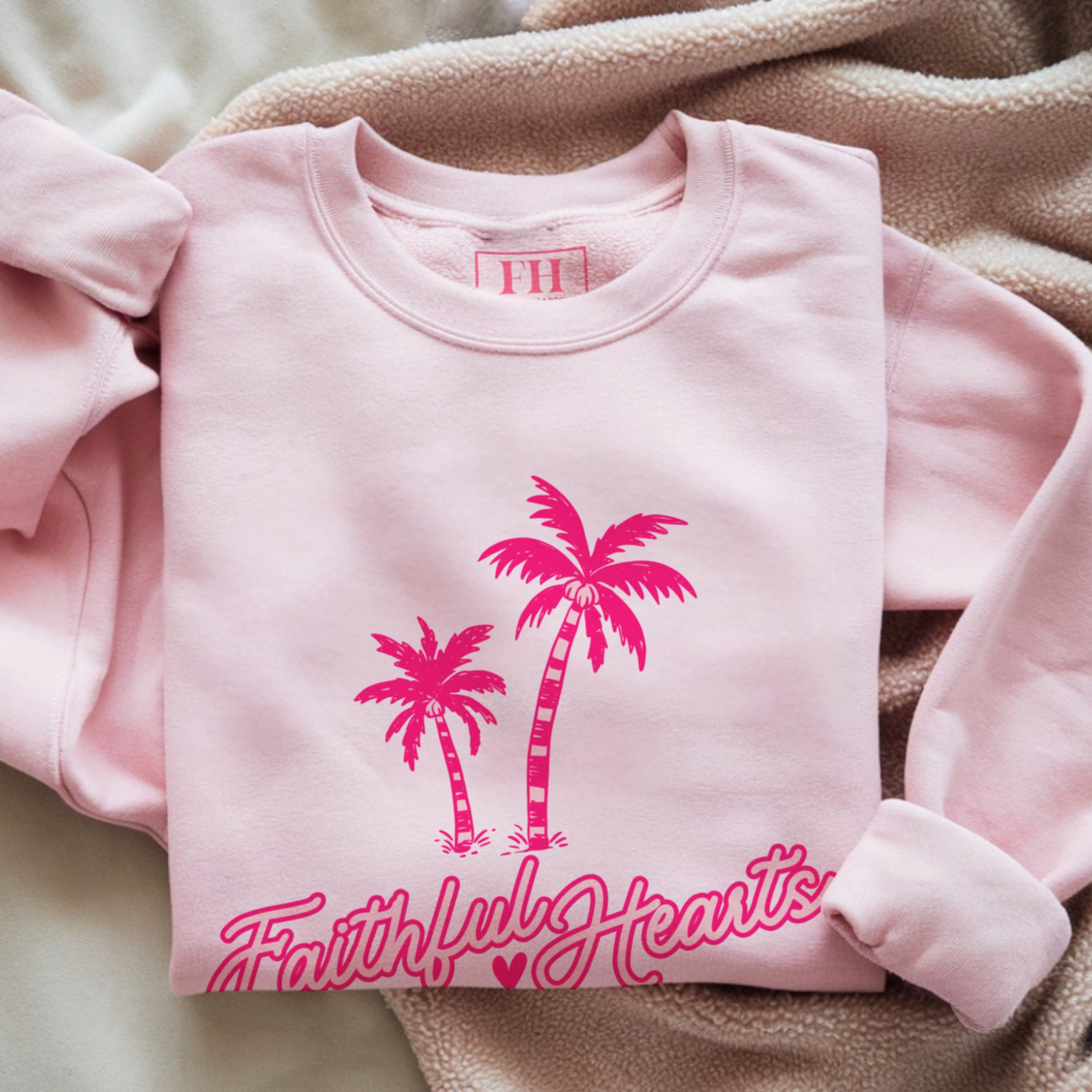 Faithful Hearts branded sweatshirt in pale pink with hot pink palm trees and script logo, aesthetic Christian faith crewneck for women