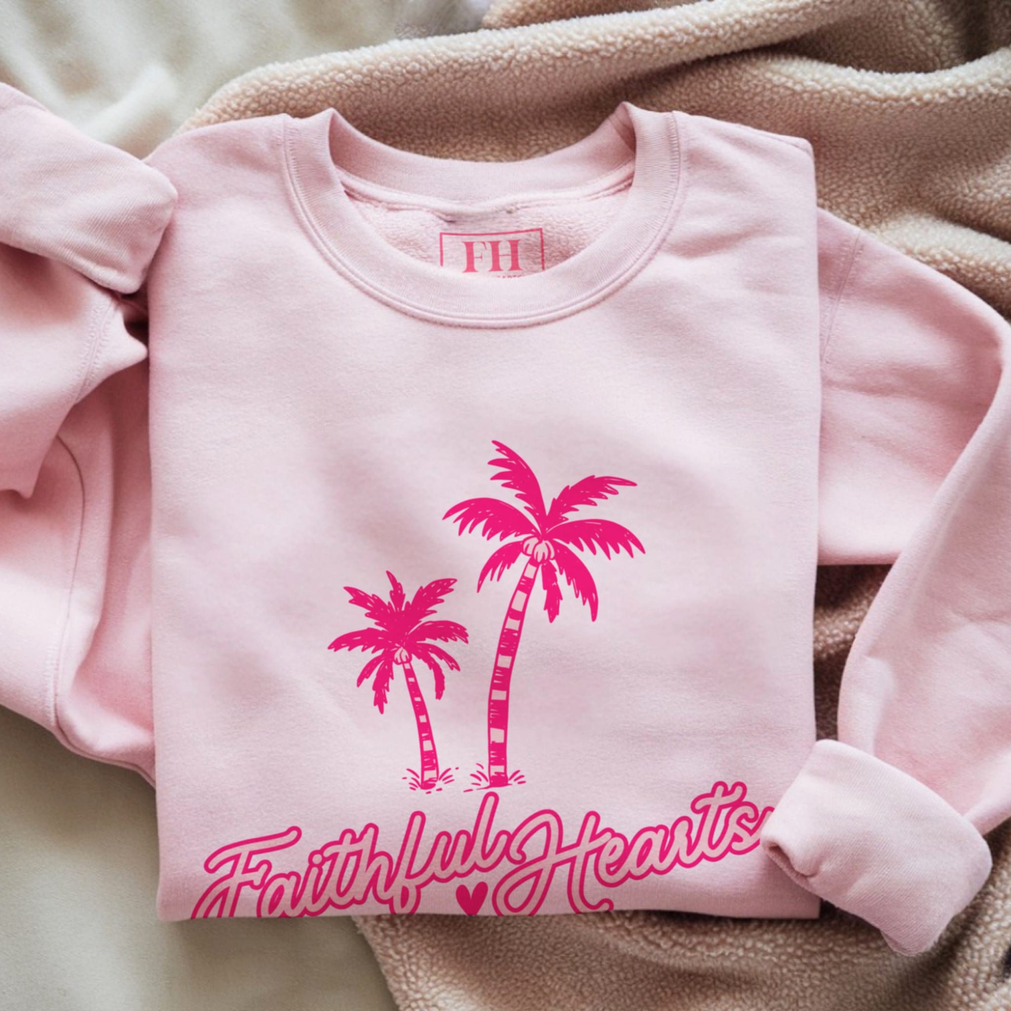 Faithful Hearts branded sweatshirt in pale pink with hot pink palm trees and script logo, aesthetic Christian faith crewneck for women