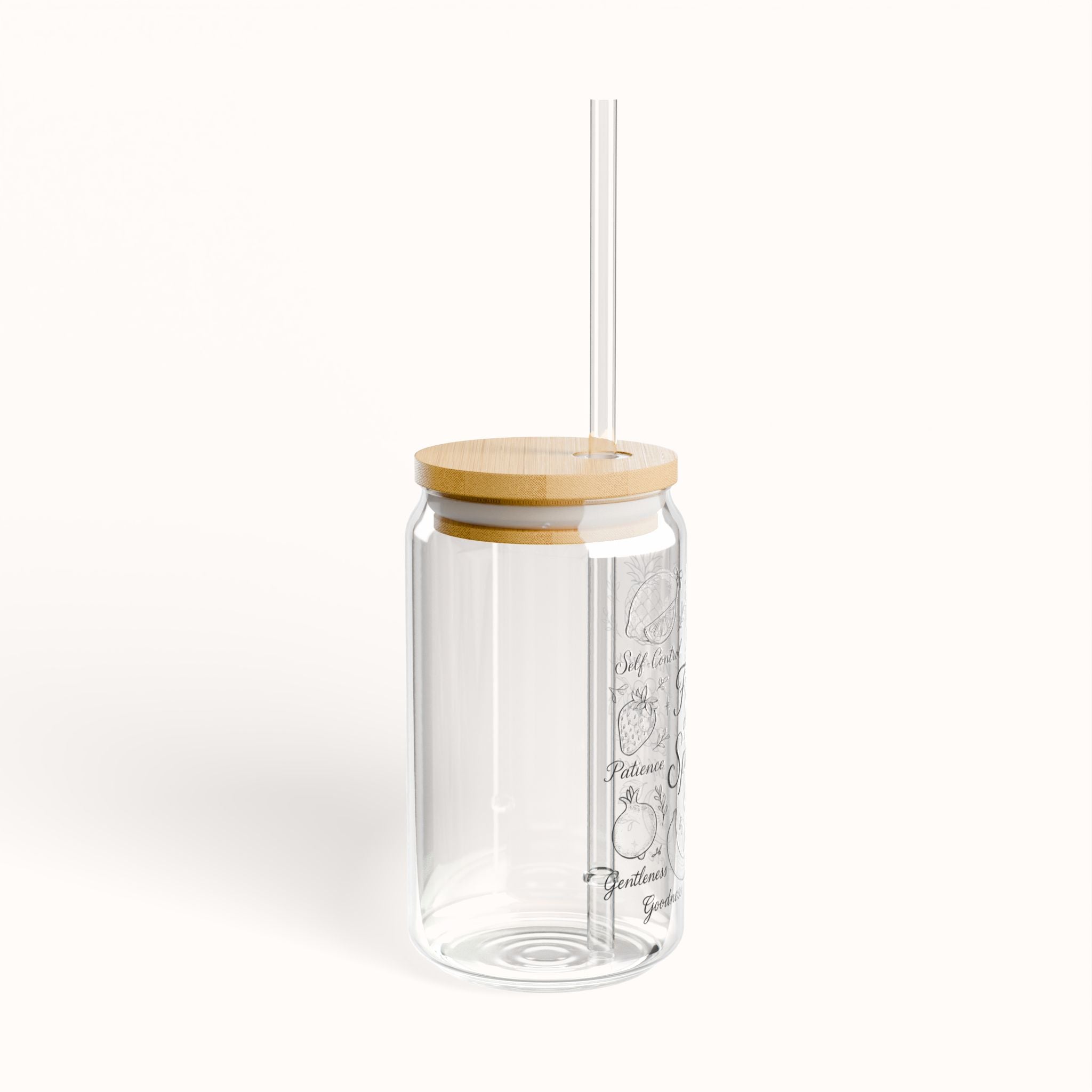 Clear glass tumbler with a wooden lid and straw on a white background