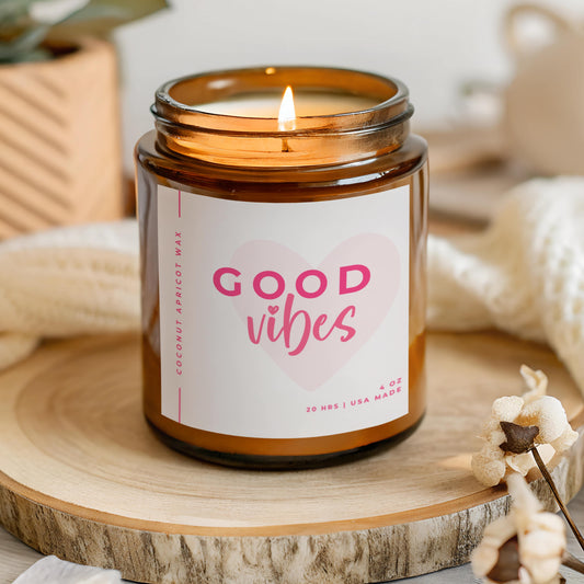 Good Vibes faith candle with pink label and heart design in amber glass jar, hand poured coconut apricot wax candle made in USA